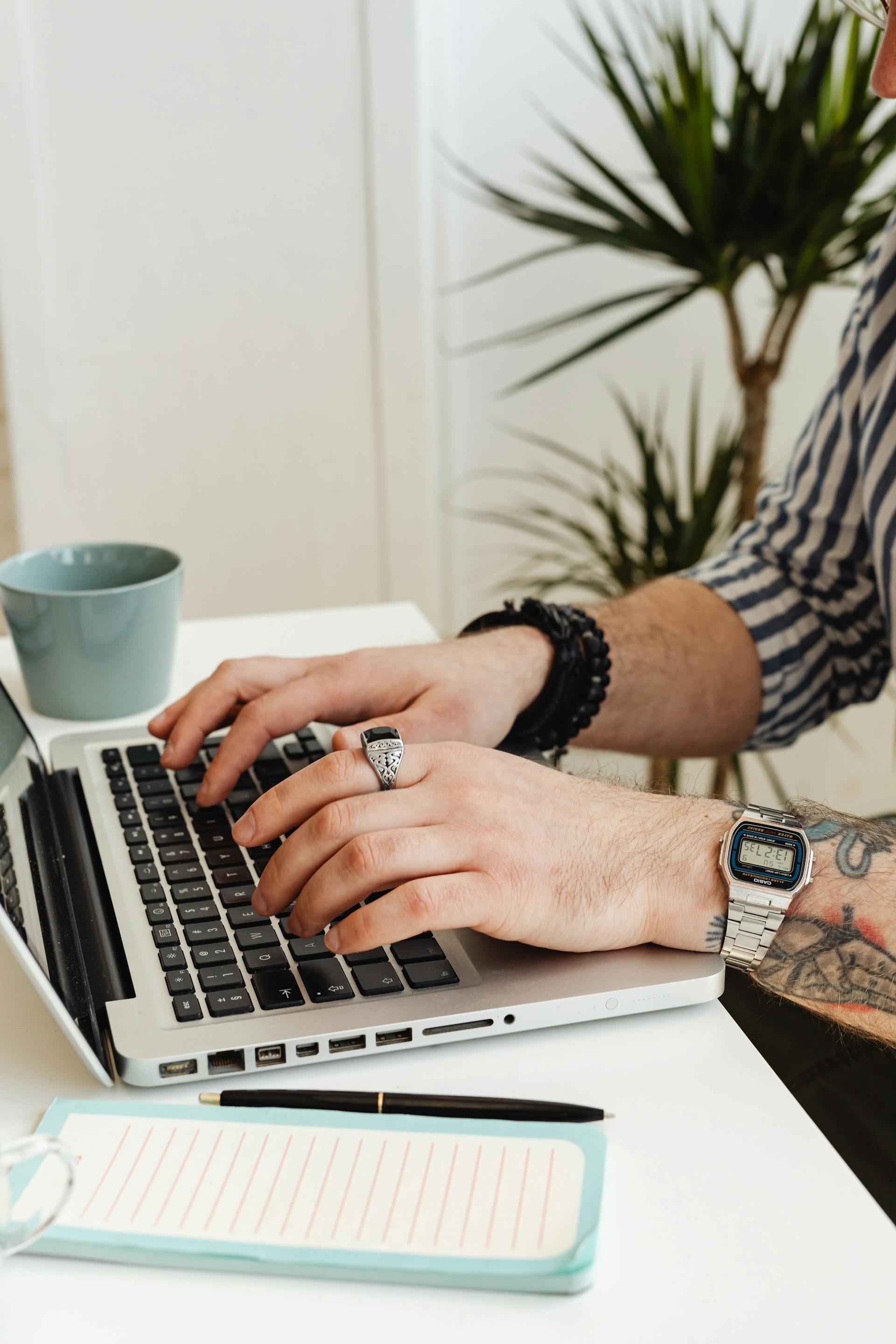 A close-up shot of a man working on his laptop | Source: Pexels