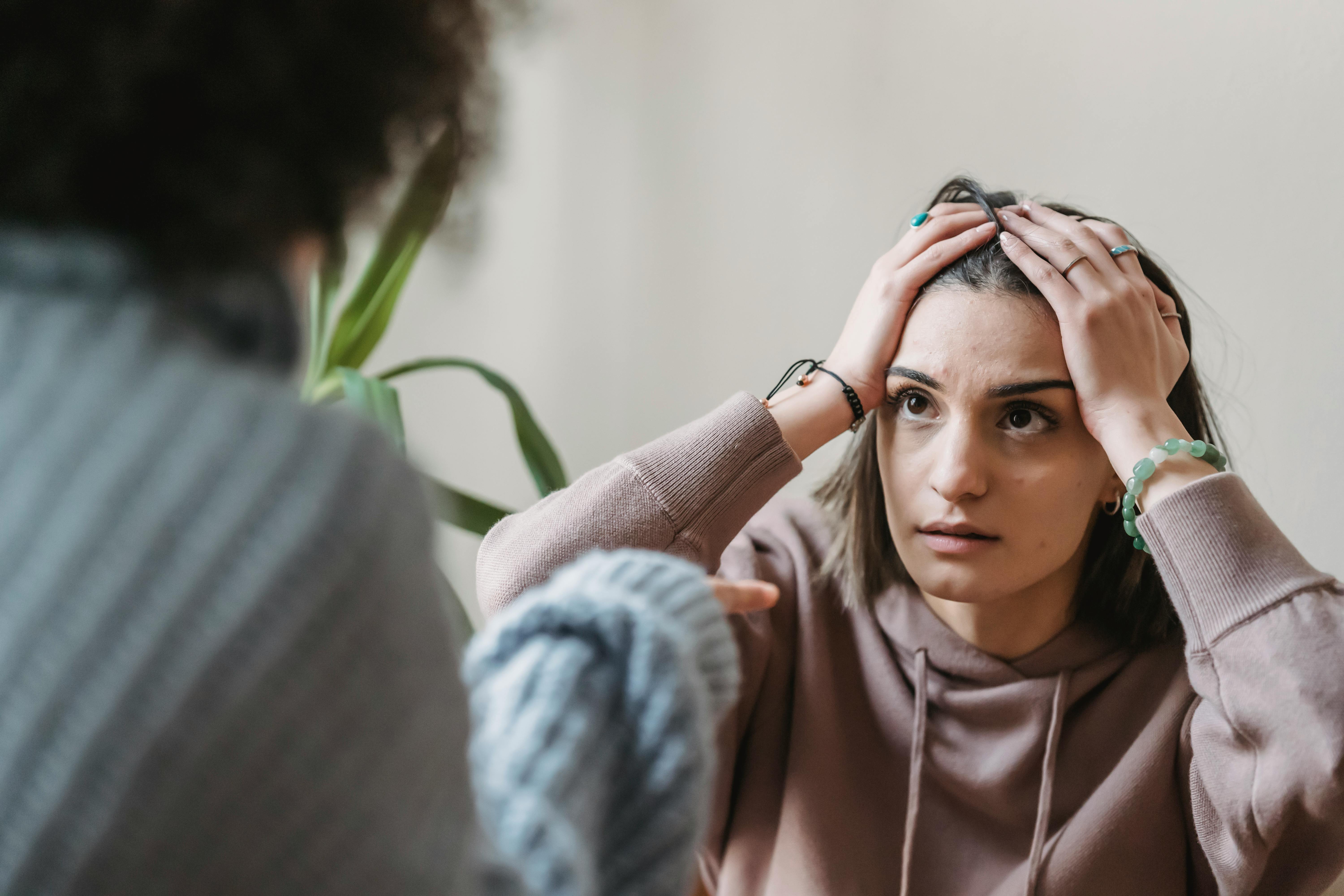 An upset woman listening to someone talk | Source: Pexels
