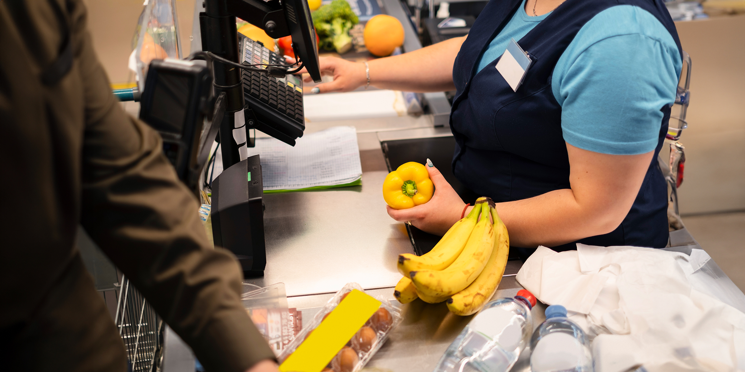 A woman cashier in a grocery store | Source: Freepik