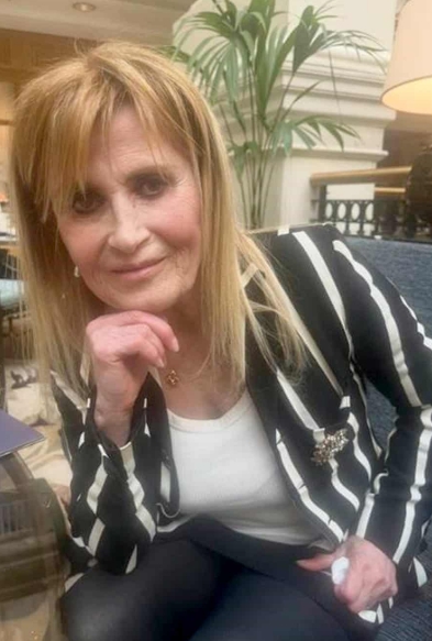 Jennifer Abbott is pictured in a relaxed setting in this image shared on 30 April 2026, wearing a striped blazer and resting her chin on her hand. | Source: X/CrimeLdn