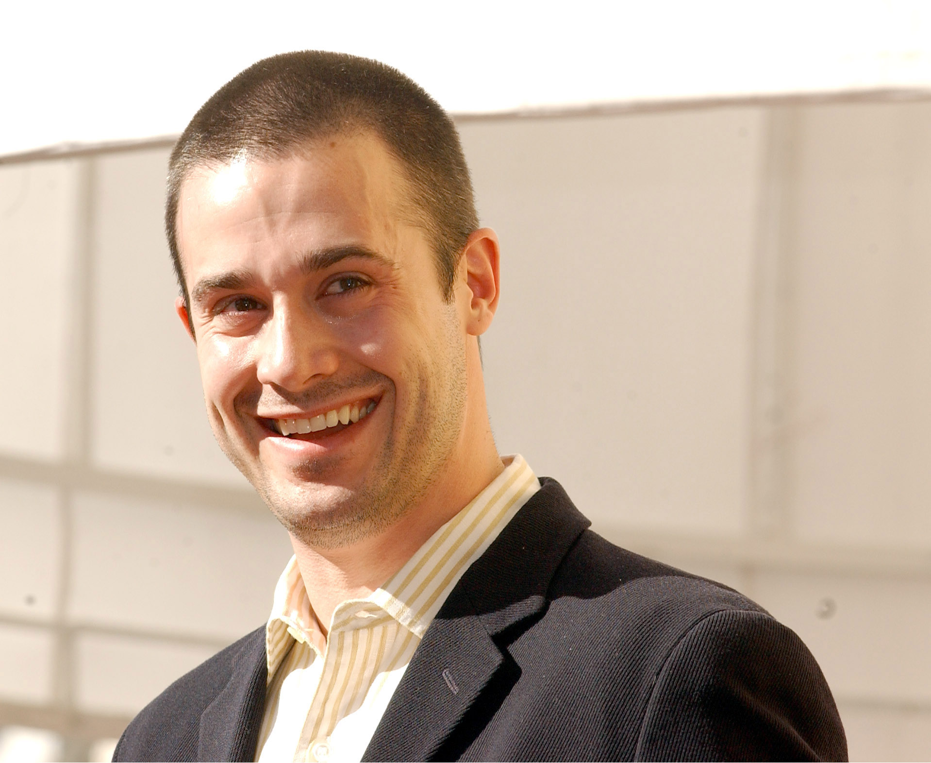 The actor accepts his father’s posthumous star on the Hollywood Walk of Fame on December 14, 2004. | Source: Getty Images