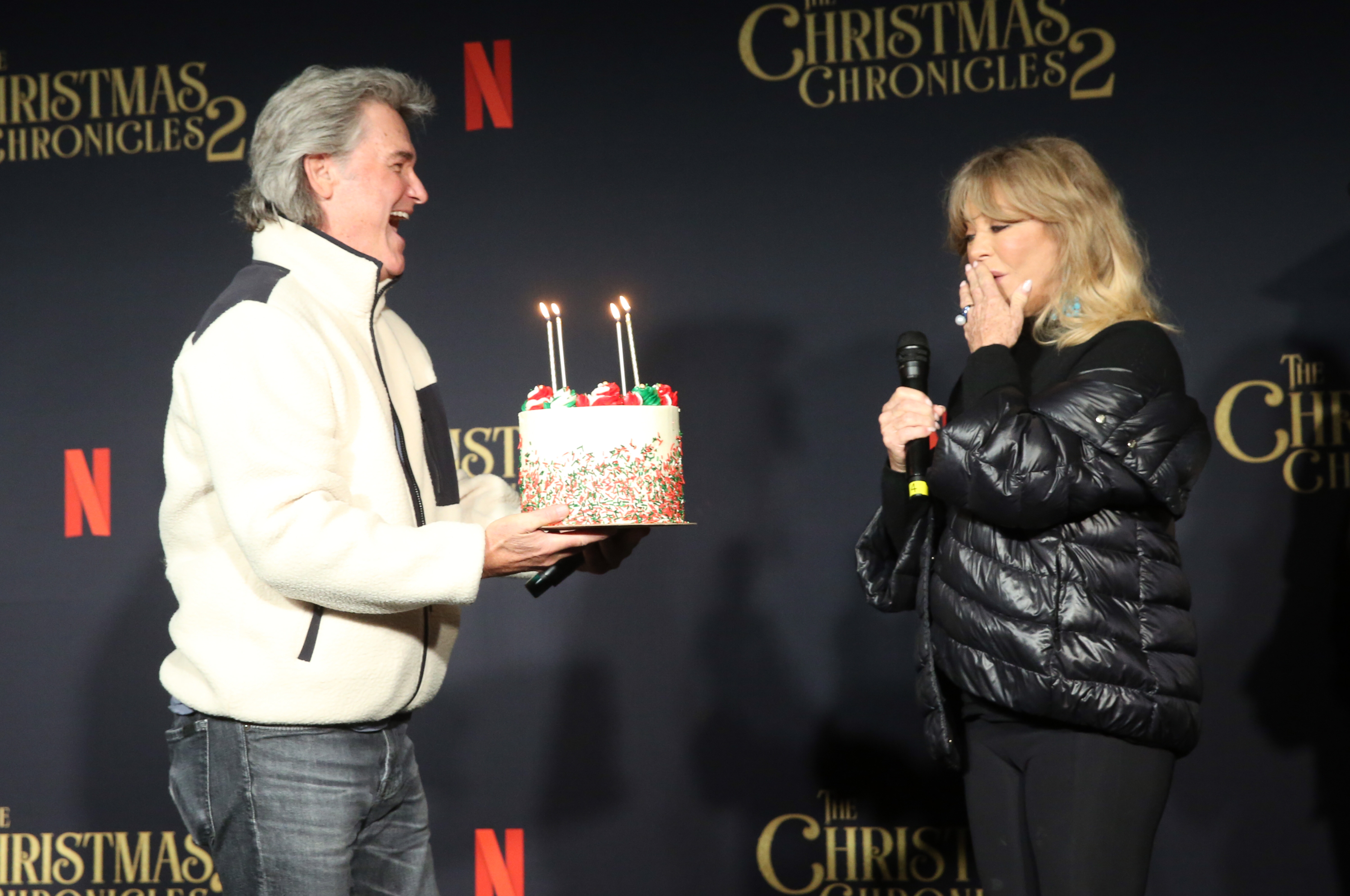 Kurt Russell presents Goldie Hawn with a cake for her milestone birthday at Netflix's "The Christmas Chronicles: Part Two" Drive-In Event at The Grove on November 19, 2020 in Los Angeles, California. l Source: Getty Images