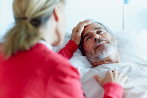 woman caressing ill man in hospital | Photo: Getty Images