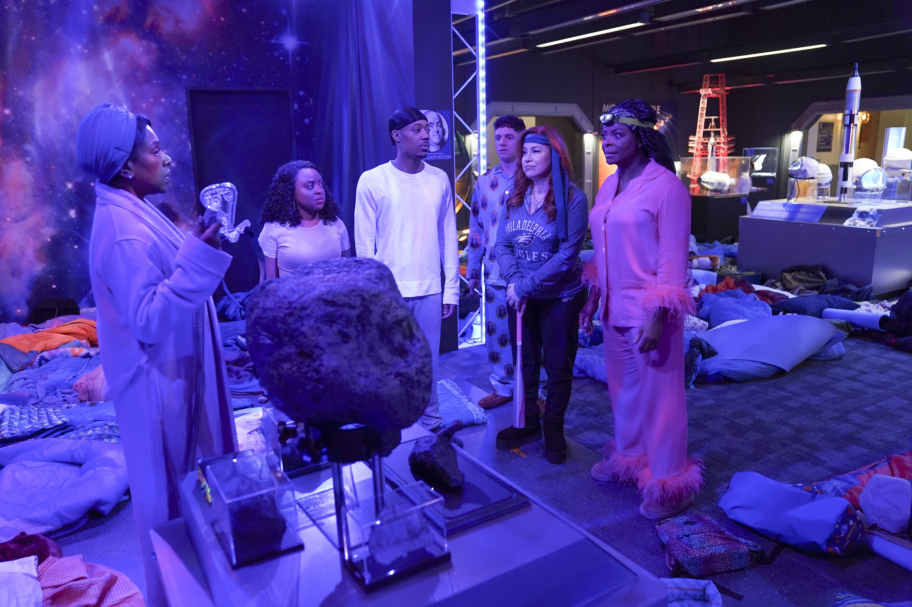 Abbott Elementary teachers in their nightwear gathered in the Galaxy Room at the Franklin Institue on the season two finale of "Abbott Elementary." | Source: Getty Images