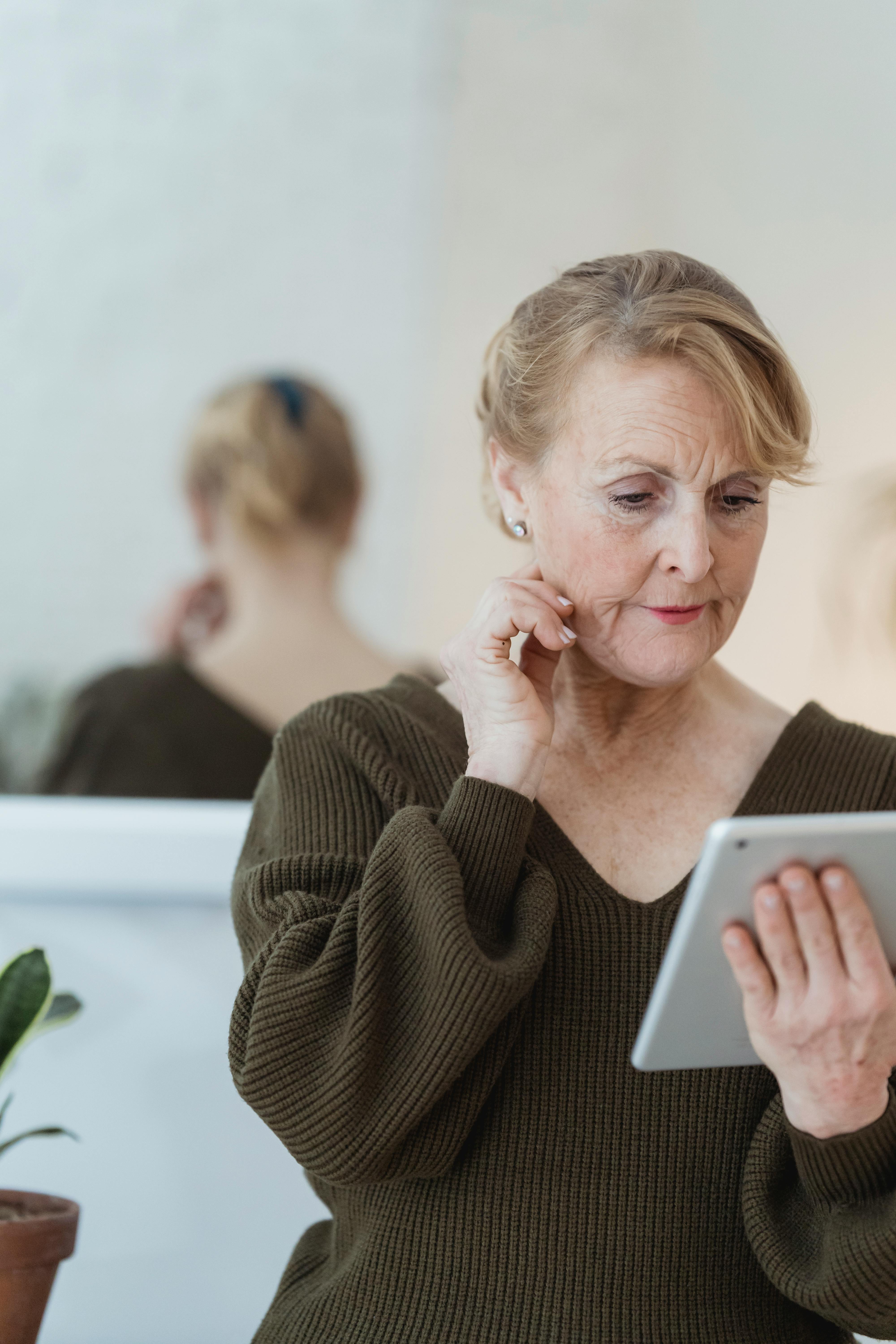 A middle-aged woman using a tablet in her free time | Source: Pexels