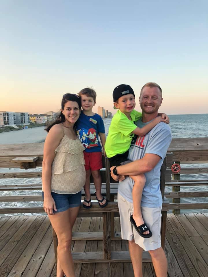 Jason, Laura, and their sons Owen and Luke Hughes posing on a pier, from a post dated July 28, 2019 | Source: Facebook/Jason Hughes
