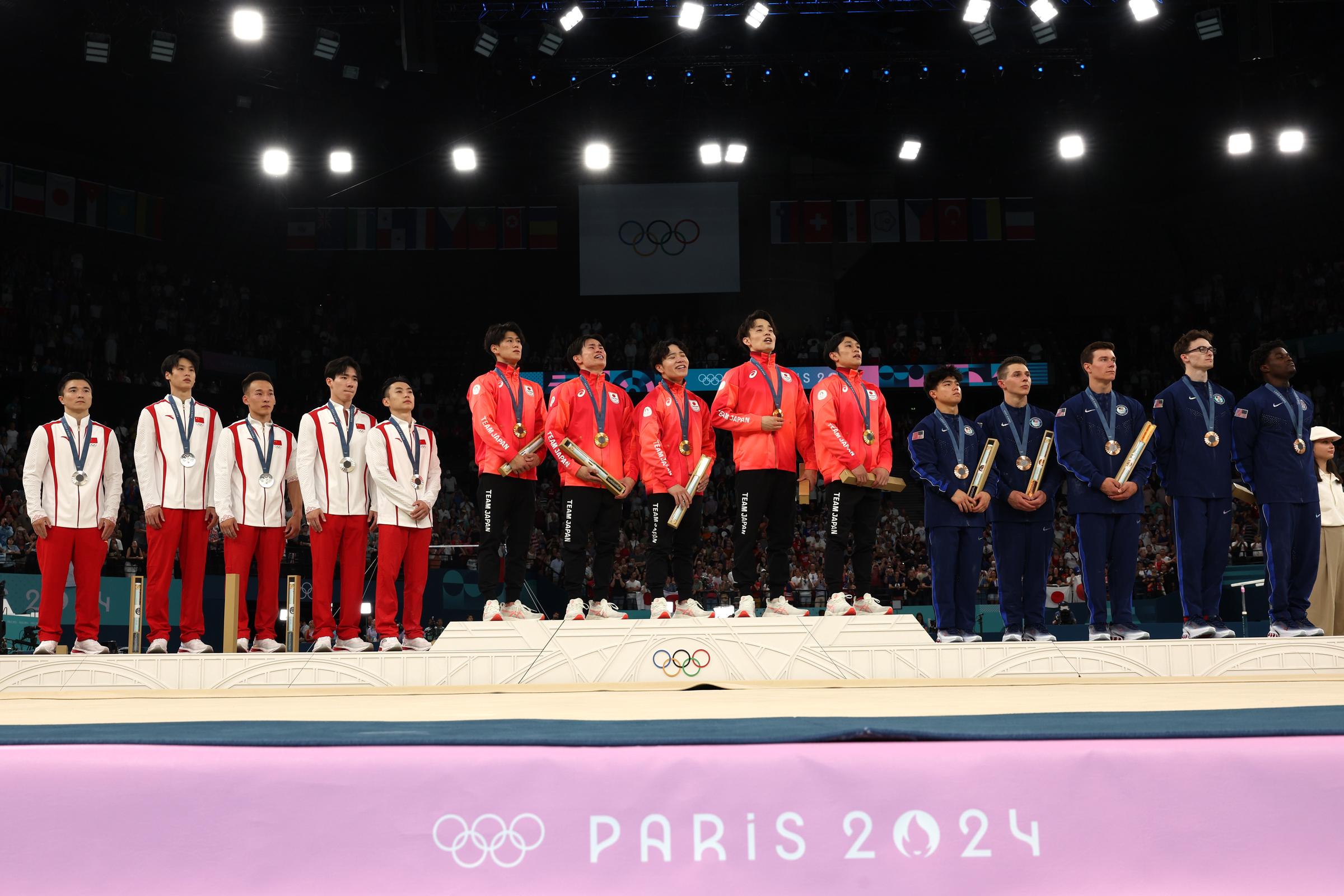 Silver medalists Team People's Republic of China , Gold medalists Team Japan and Bronze medalists Team United States celebrate on the podium on July 29, 2024 | Source: Getty Images