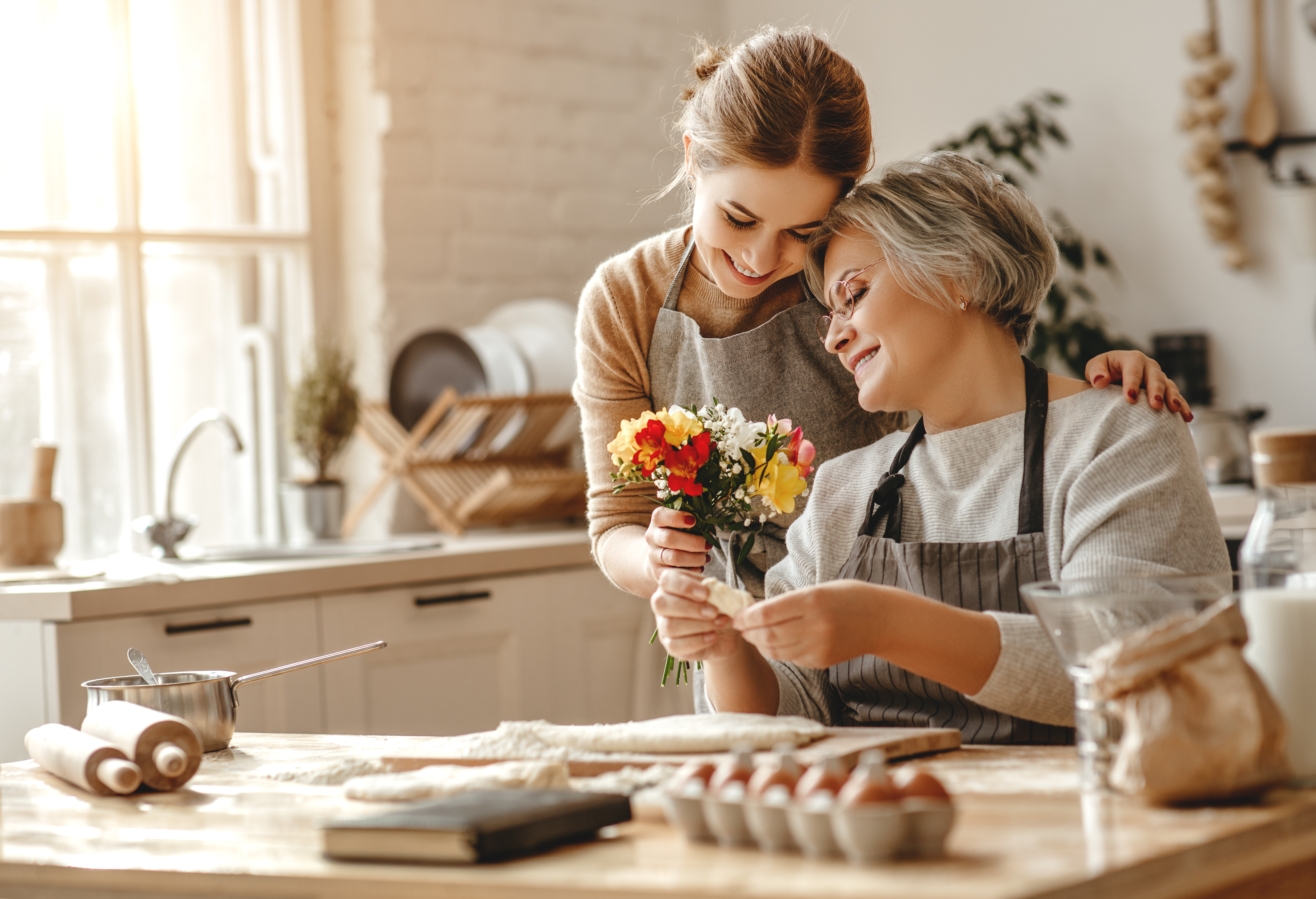 A woman lovingly embracing her mother-in-law | Source: Shutterstock