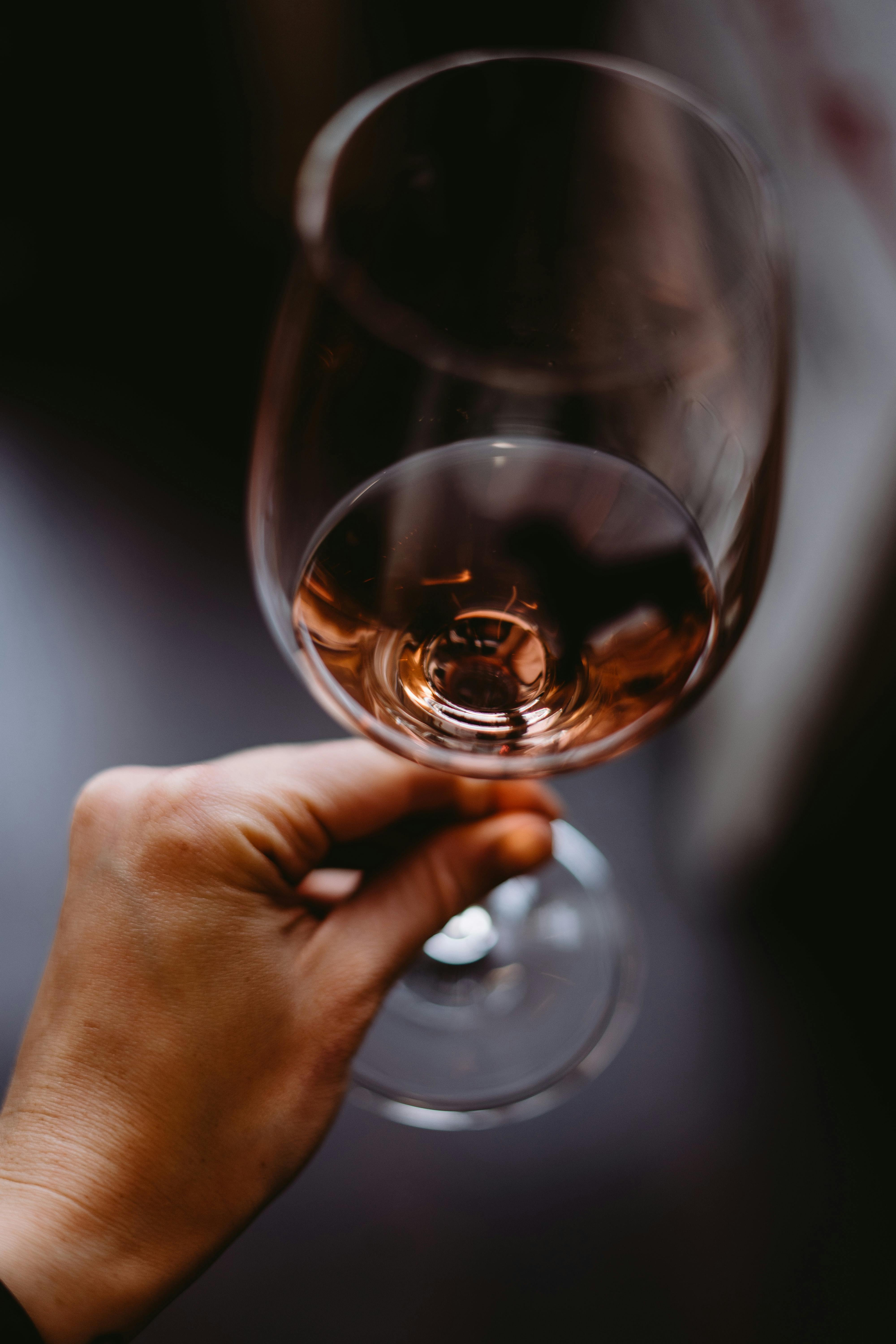 Someone holding up a glass for a toast | Source: Pexels