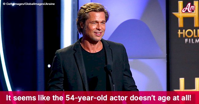 Brad Pitt looks age-defying in a velvet tux on the red carpet, showing off his adorable grin