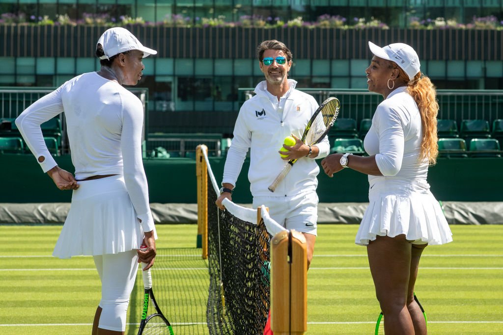 Serena Williams with sister Venus Williams of the United States and coach Patrick Mouratoglou at training before the start of the Wimbledon Lawn Tennis Championships | Photo: Getty Images