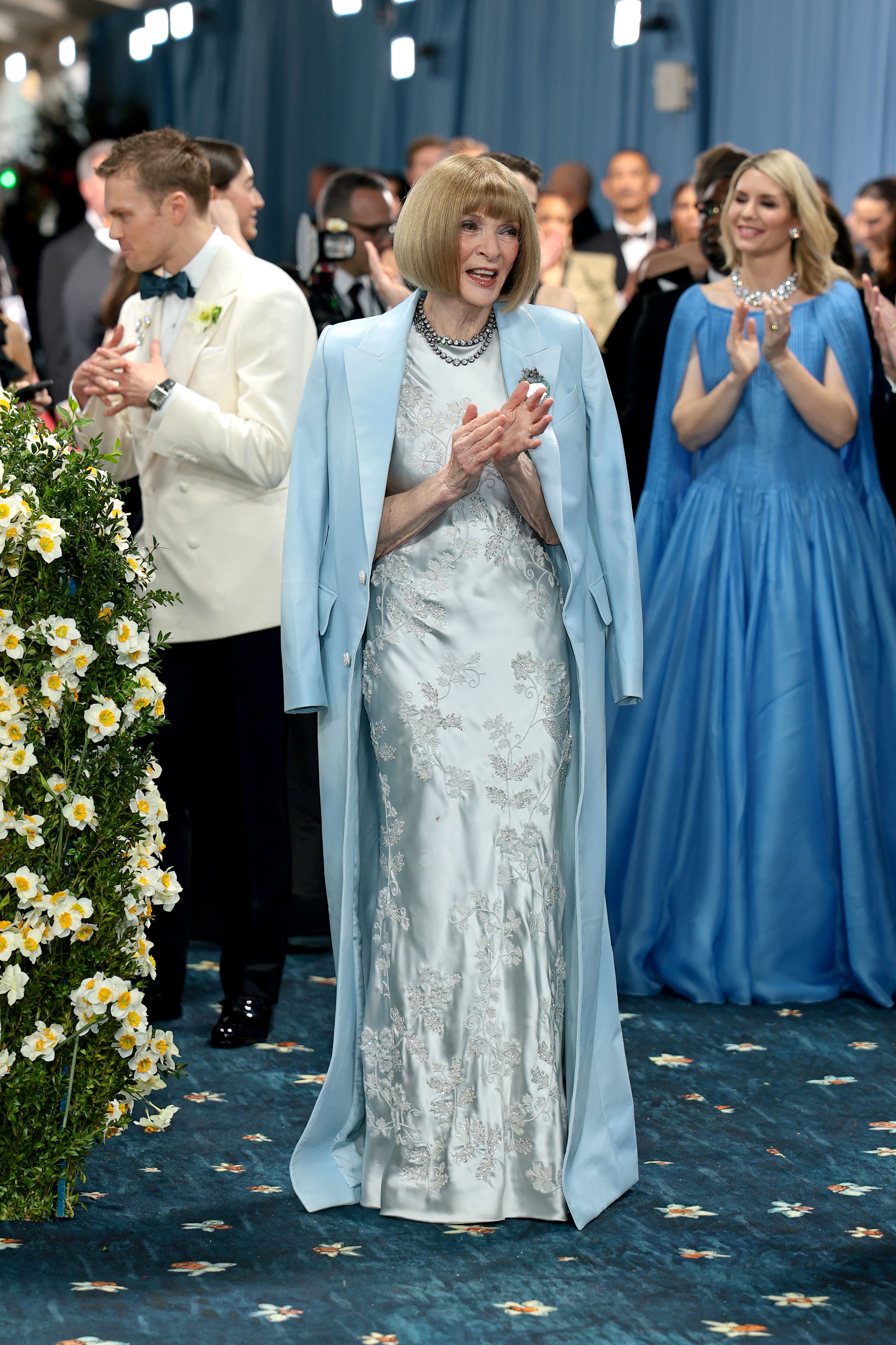 Smiling and applauding inside the venue, Anna Wintour blends into the celebratory atmosphere at the 2025 Met Gala honoring "Superfine: Tailoring Black Style" at the Metropolitan Museum of Art in New York City.