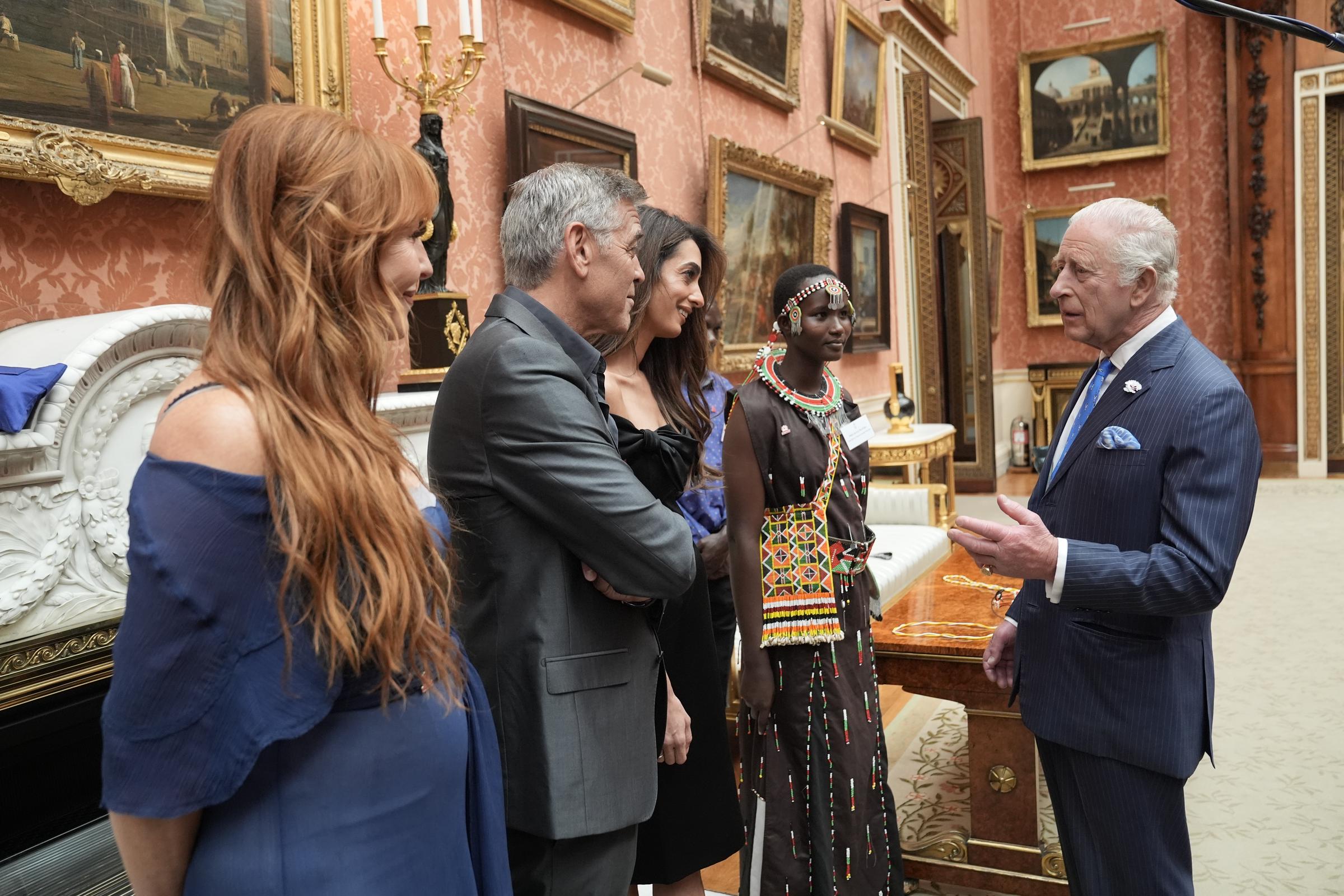 King Charles III speaks with Charlotte Tilbury, George, and Amal Clooney during a reception for the winners of the King's Trust Awards 2025 | Source: Getty Images
