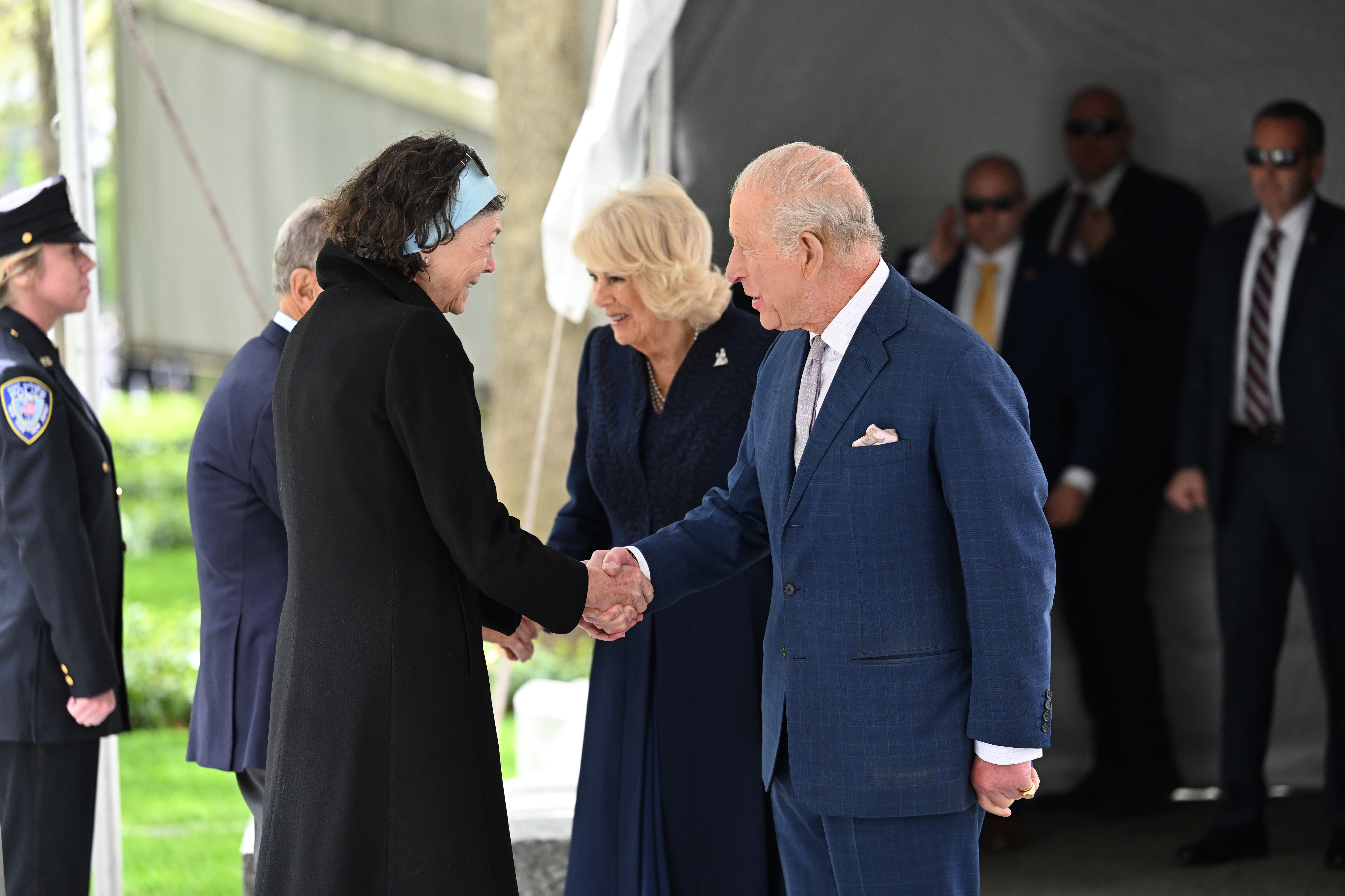 King Charles III shakes hands with an official as Queen Camilla stands nearby during a visit to the 9/11 Memorial on April 29, 2026 | Source: Getty Images