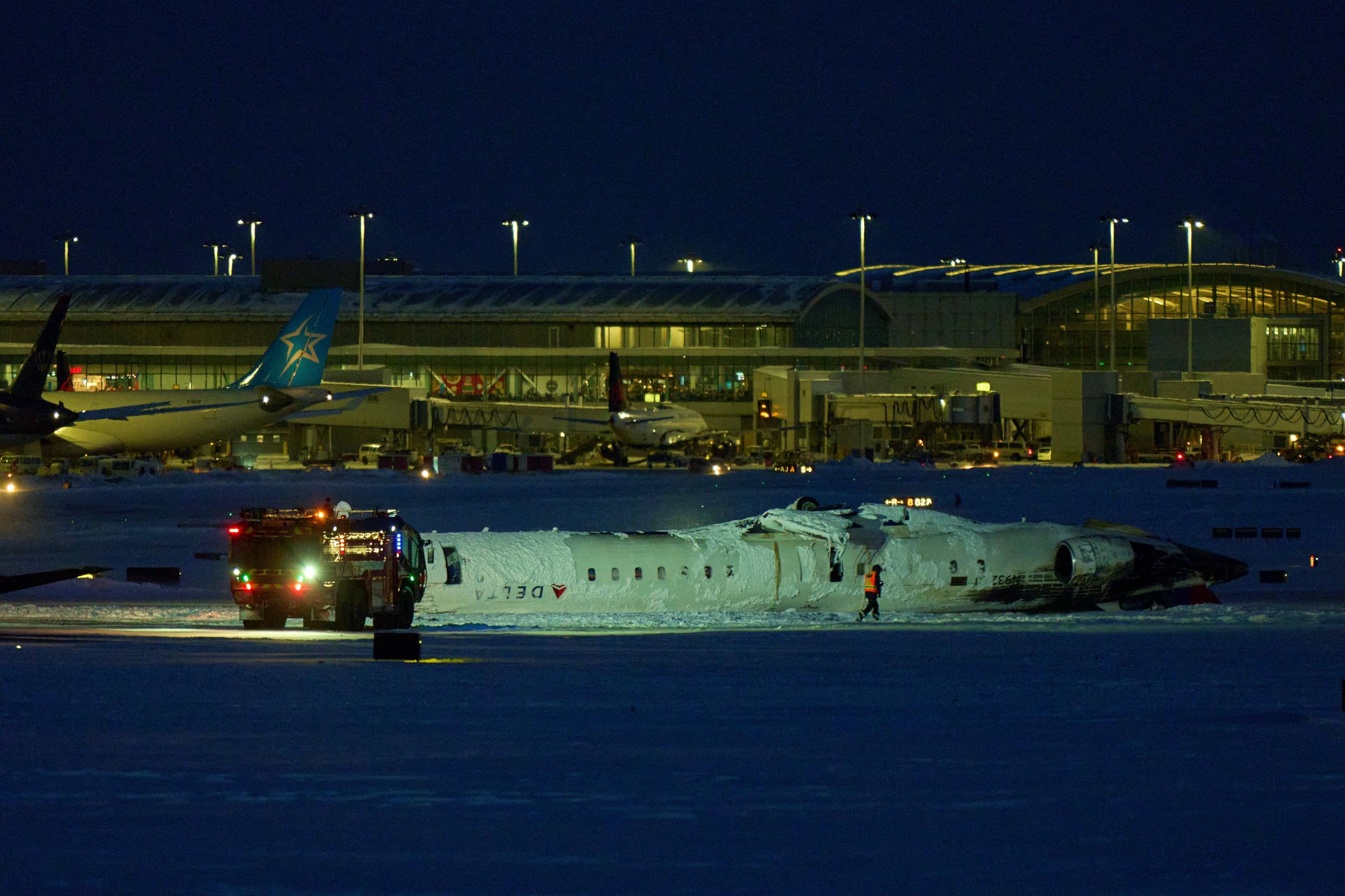 A Delta airlines plane sits on its roof after crashing upon landing on February 17, 2025 | Source: Getty Images