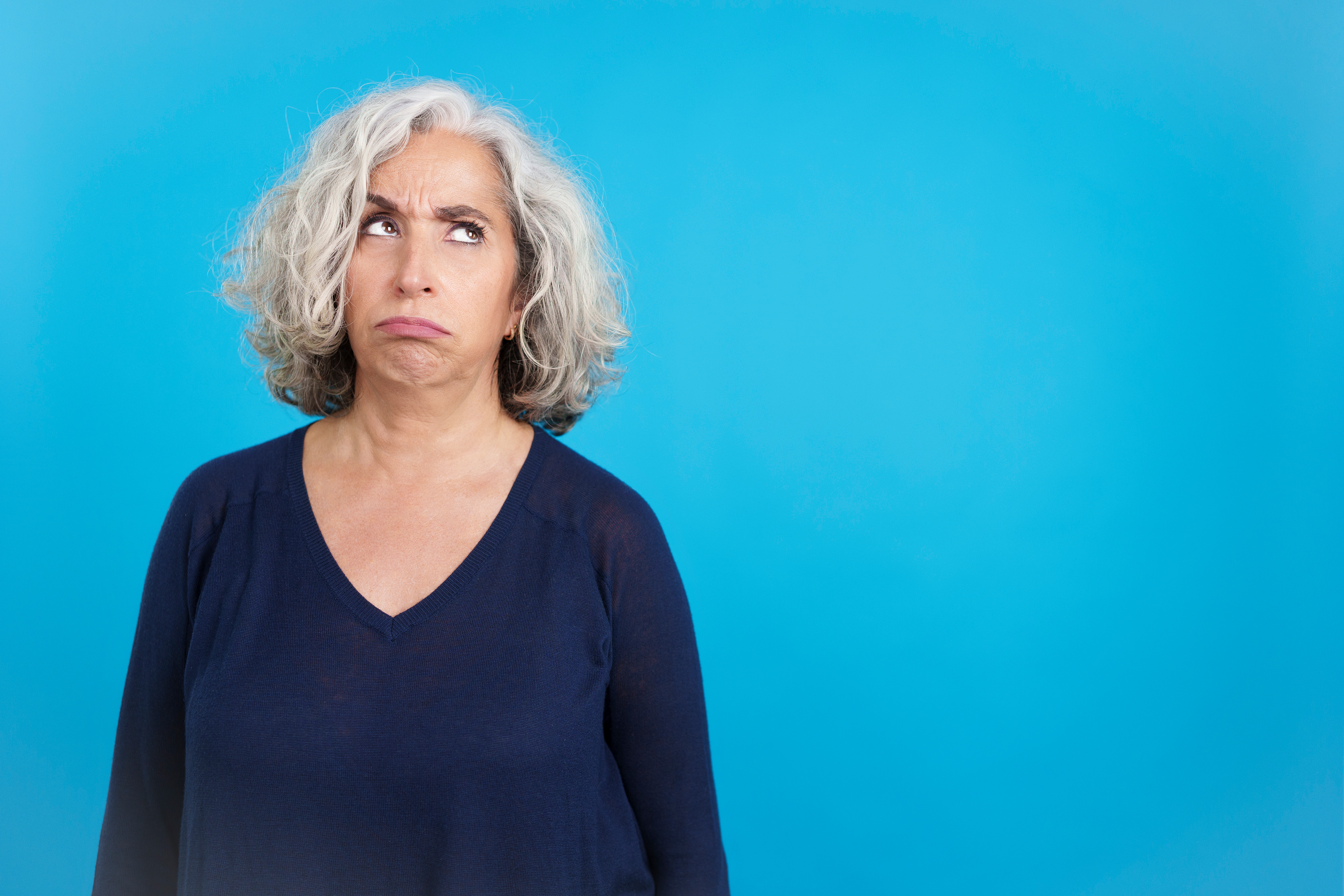 Mature woman looking up with an expression of discontent | Source: Getty Images