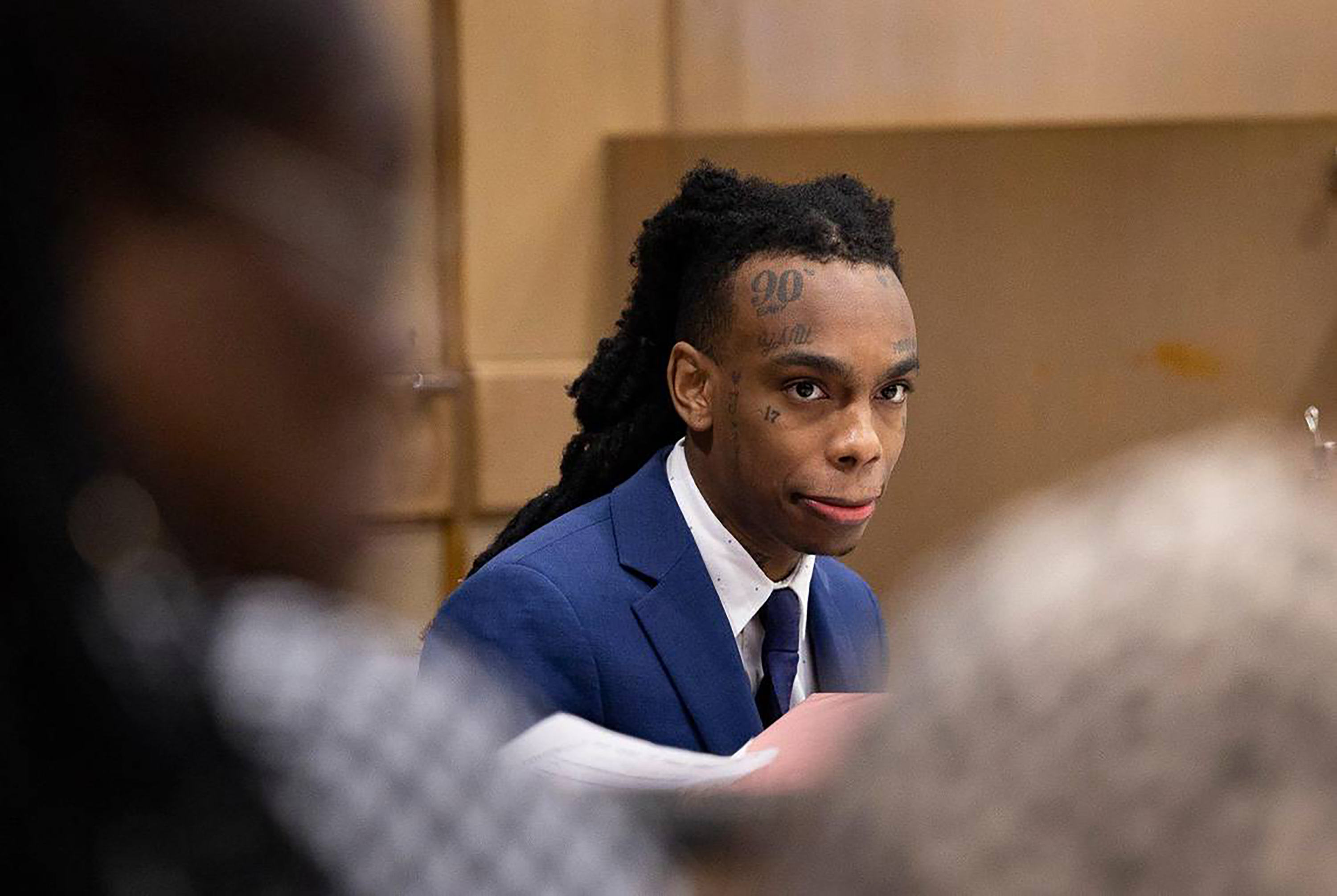 Jamell Demons, better known as YNW Melly, looks out at friends and family walking into the courtroom during his double murder trial on June 20, 2023, at Broward County Courthouse in Fort Lauderdale, Florida | Source: Getty Images
