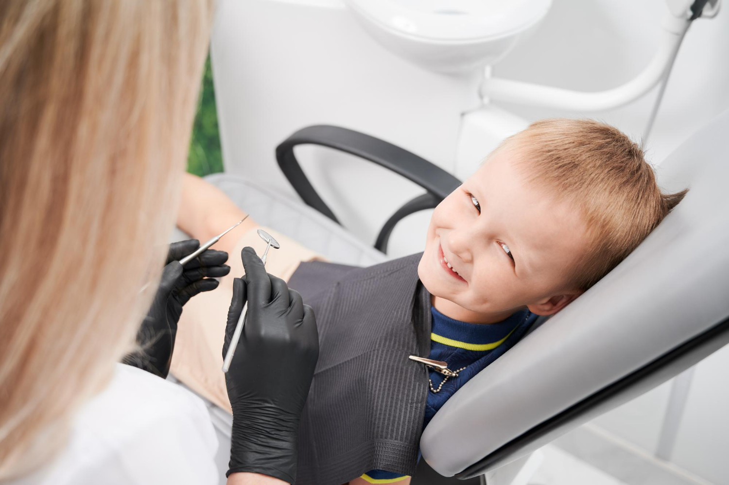 A little boy sitting on a dental chair | Source: Freepik