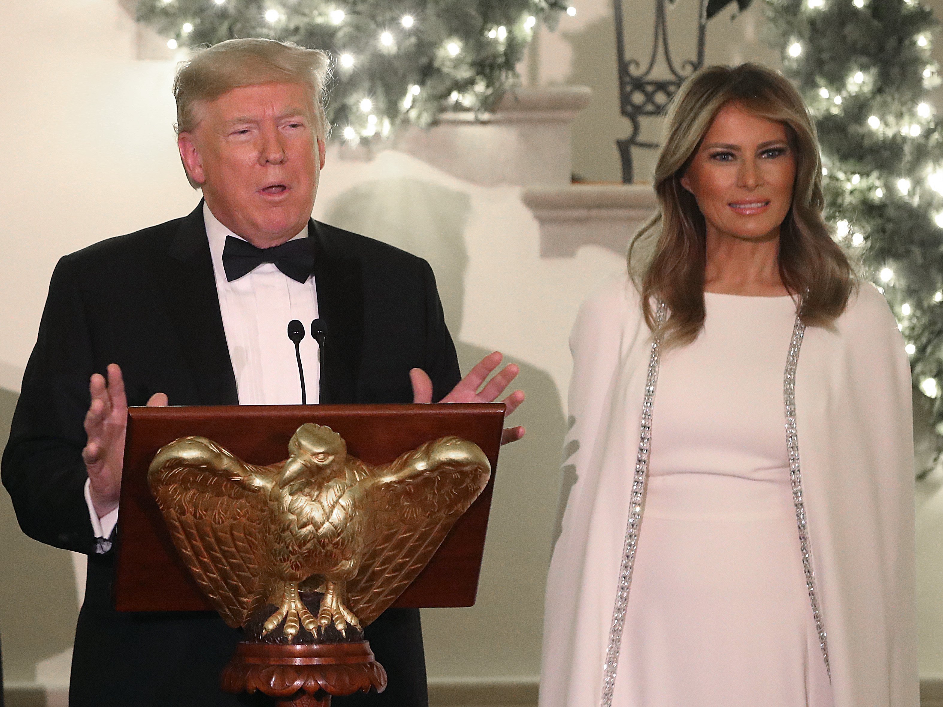 U.S. President Donald Trump speaks as first lady Melania Trump (R), Vice President Mike Pence and his wife Karen Pence look on during a Congressional Ball in the Grand Foyer of the White House on December 12, 2019 in Washington, DC. | Photo: Getty Images