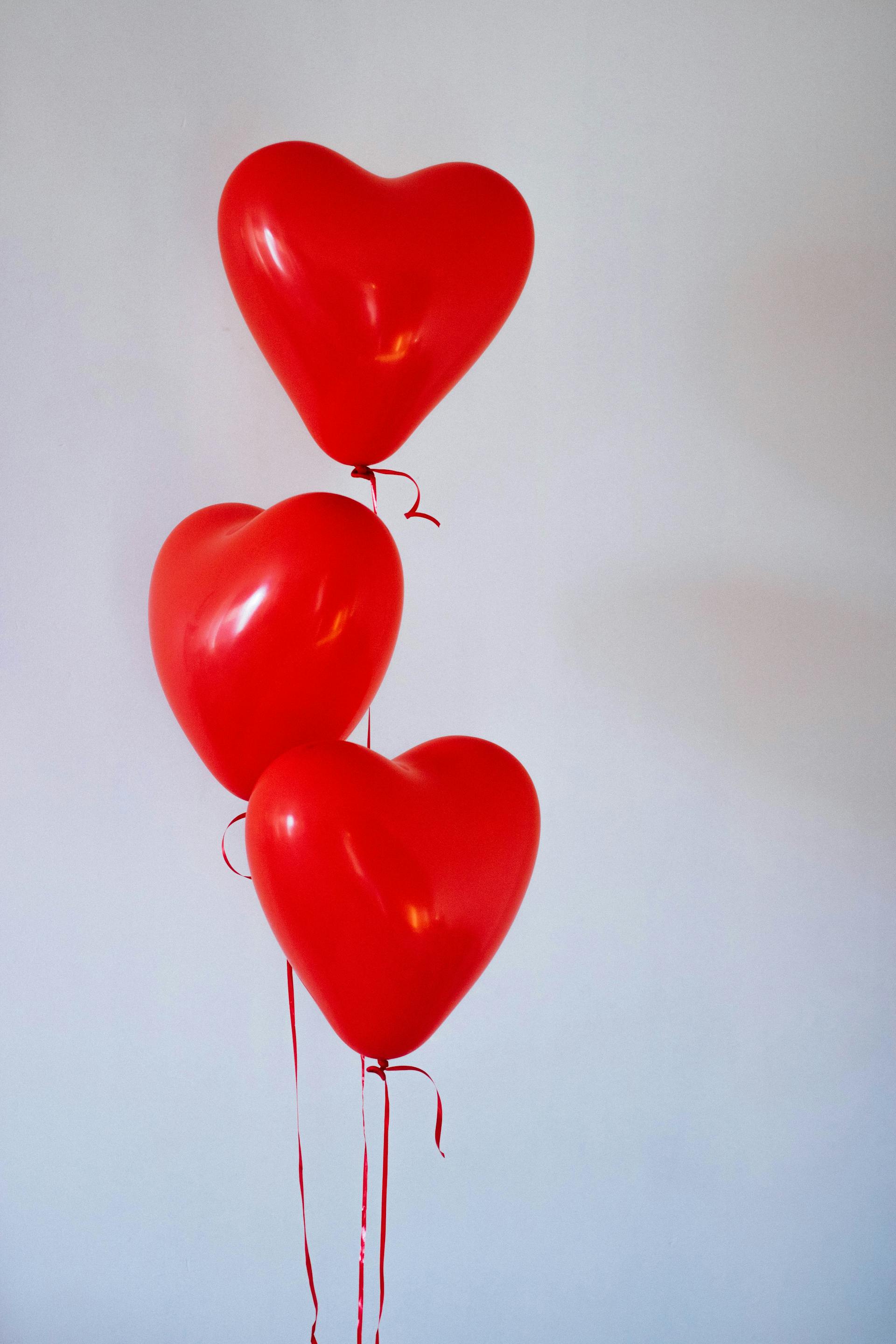 Three red heart-shaped balloons | Source: Pexels
