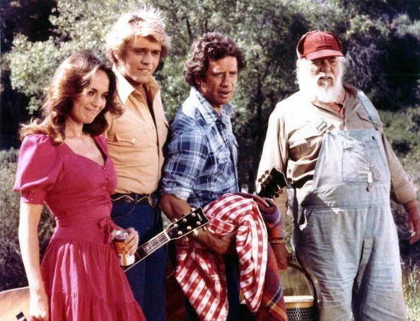 Undated photo of John Schneider, Tom Wopat, Catherine Bach, and Denver Pyle from the action-comedy television series "The Dukes of Hazzard," which aired from 1979 to 1985. | Photo: Getty Images