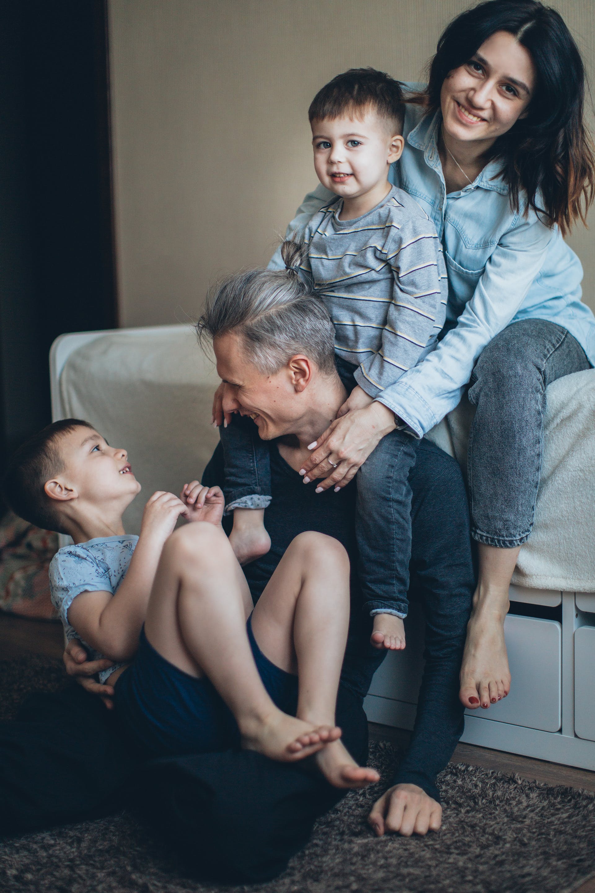 A happy couple playing with their two sons | Source: Pexels