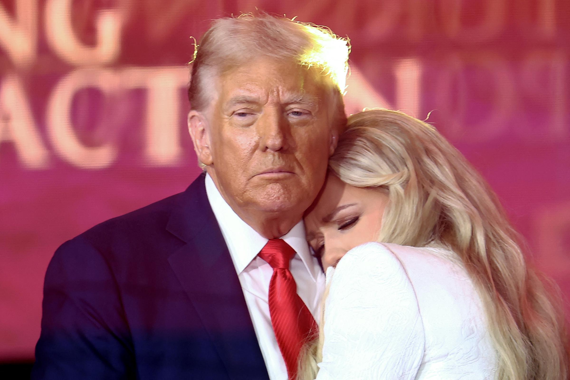 President Donald Trump embraces Erika Kirk, after speaking at the public memorial service for Charlie Kirk at State Farm Stadium on September 21, 2025 | Source: Getty Images