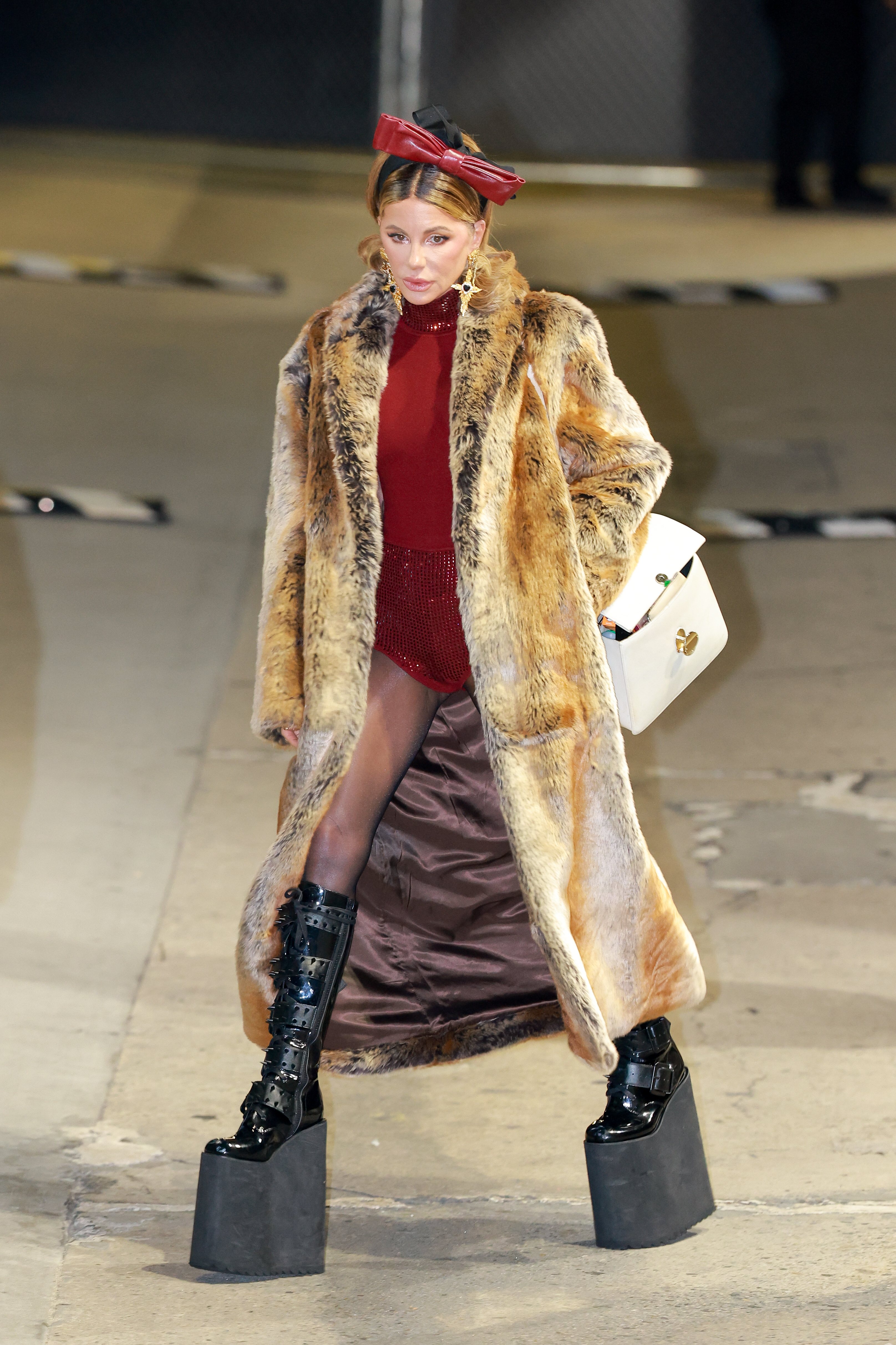 Kate Beckinsale's toned body can be noted even more here. For her age, she maintains slim legs, covered by dark, slightly translucent pantyhose. More of the belt buckles on her combat boots can also be detailed.