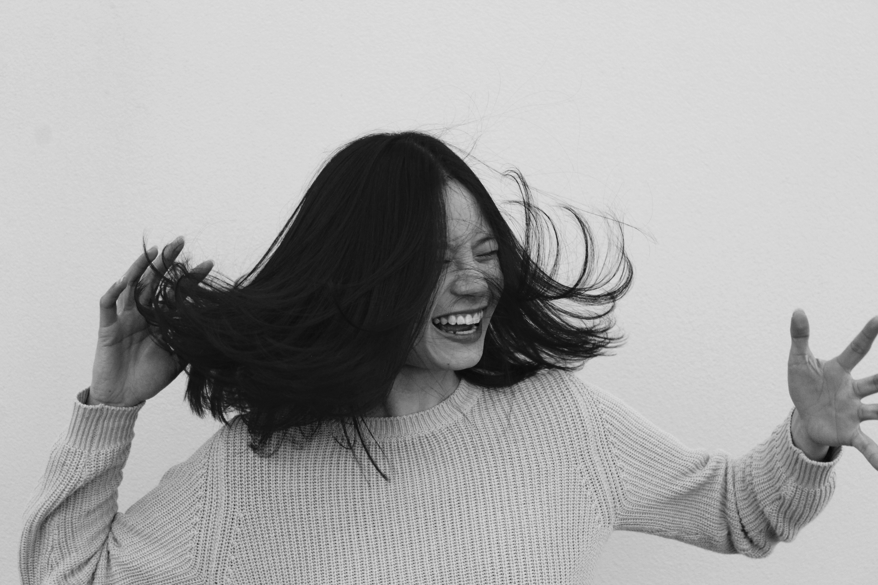 A woman laughing. │Source Unsplash