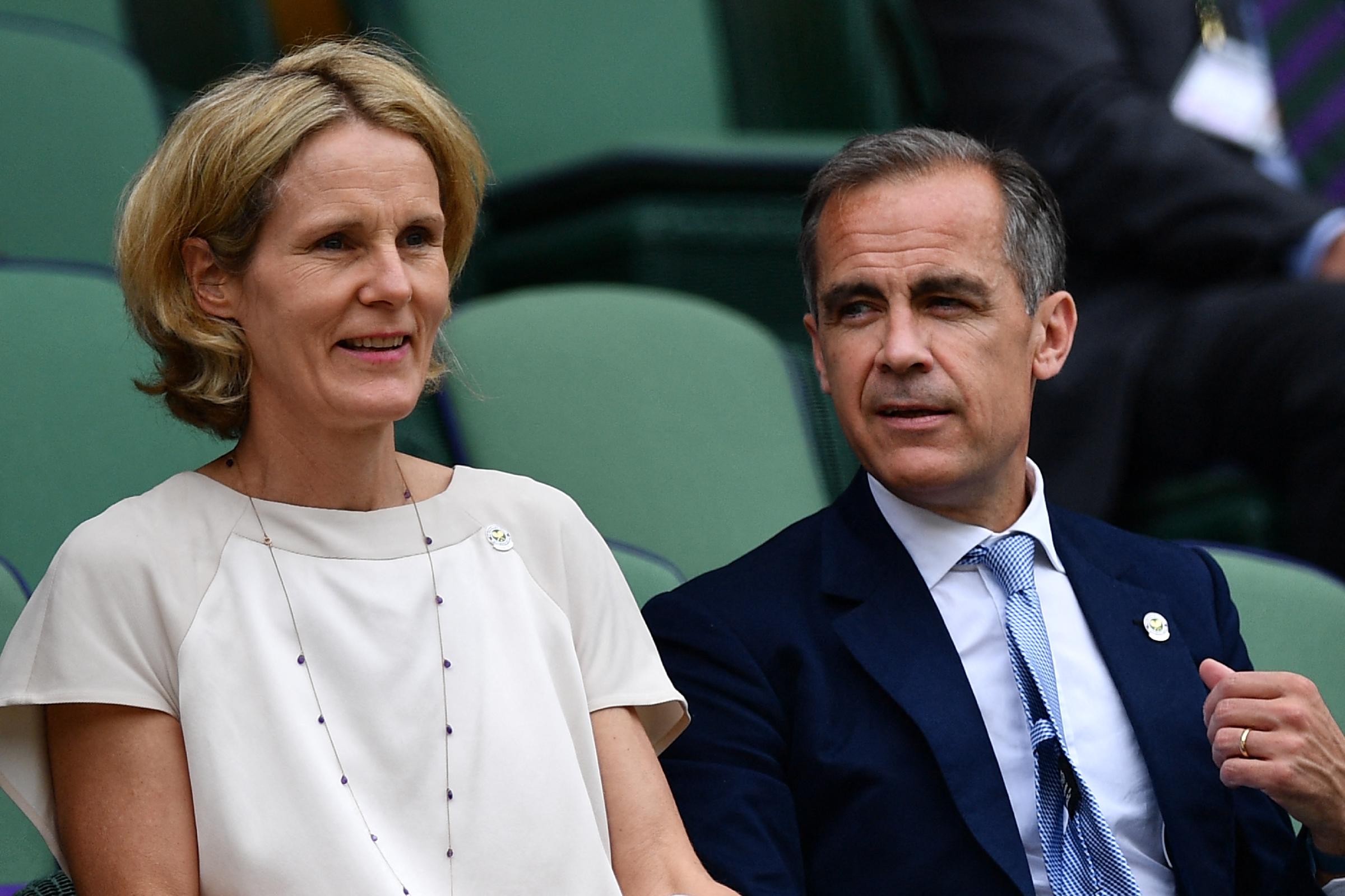 Mark Carney and Diana Fox Carney sit in the royal box on centre court before the men's semi-final match on the twelfth day of the Wimbledon Championships at The All England Lawn Tennis Club in Wimbledon, southwest London, on July 8, 2016 | Source: Getty Images