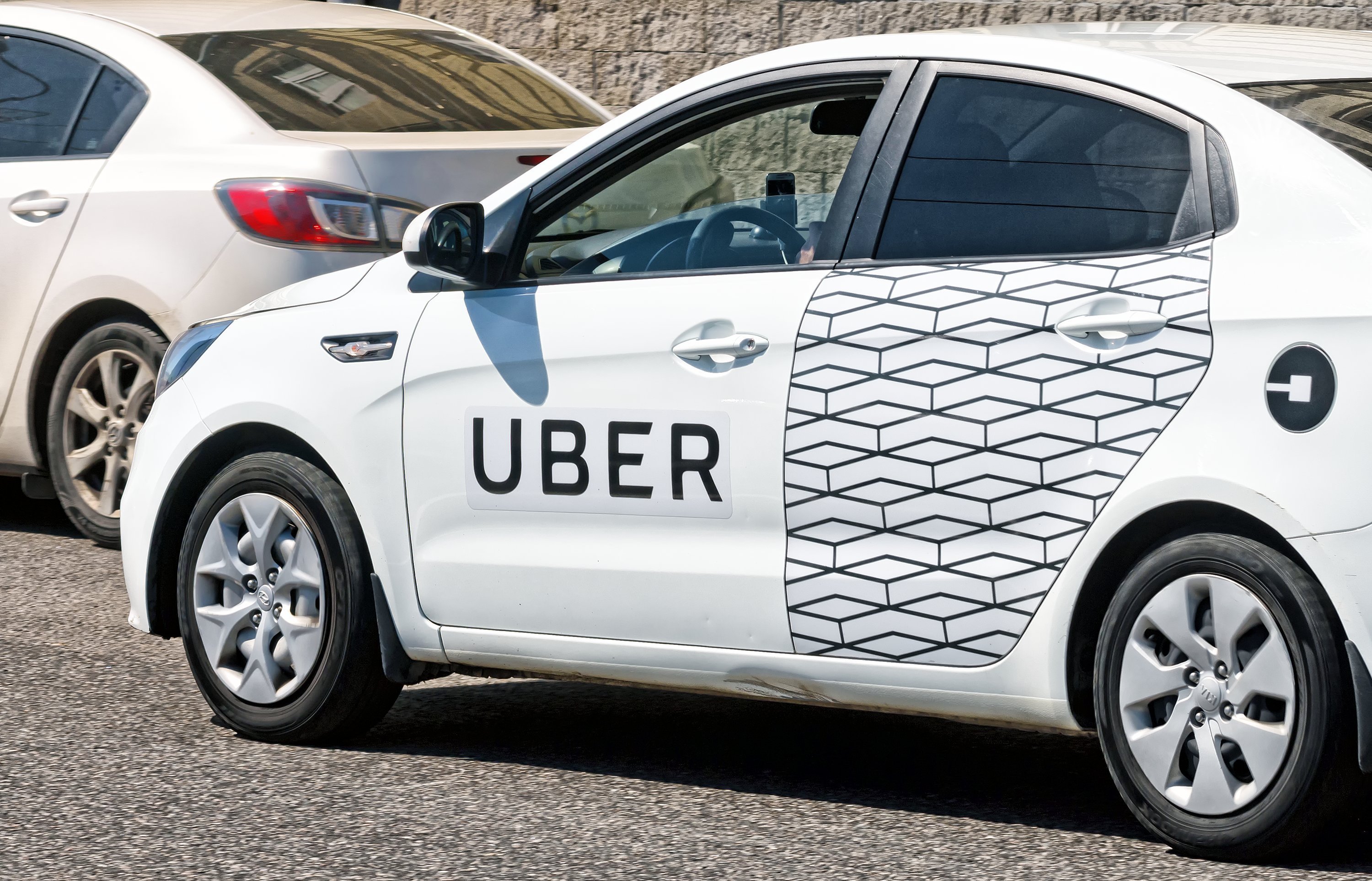 White car with Uber decals. | Source: Shutterstock