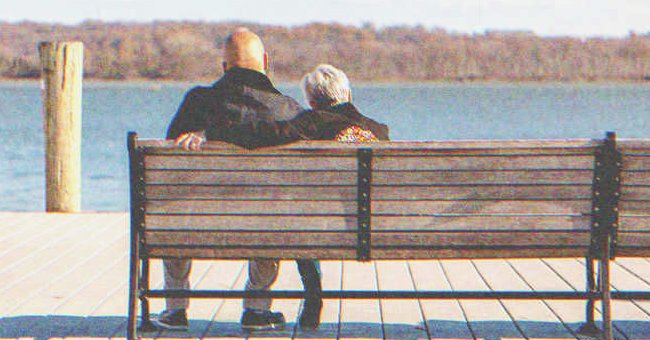 Old couple sitting on a bench | Source: Shutterstock