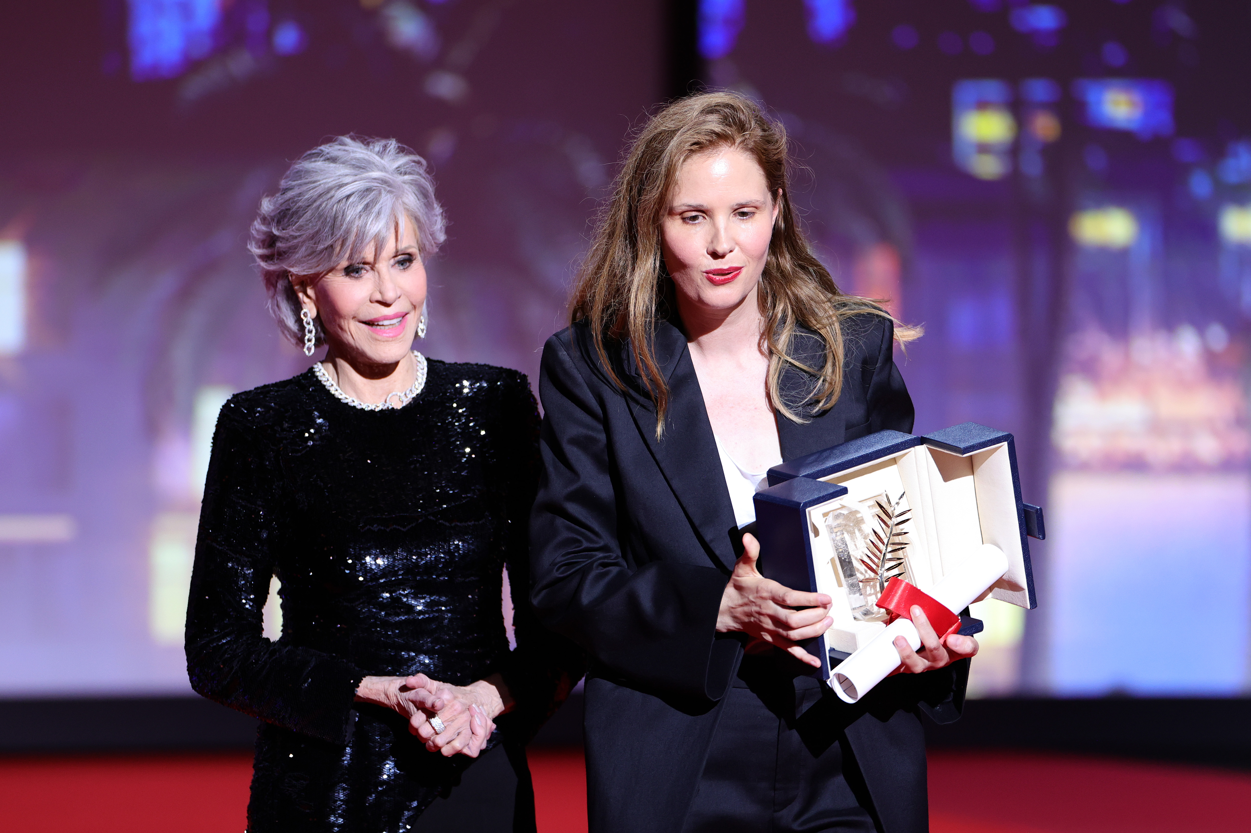 Justine Triet receiving the Palme d'Or Award for "Anatomy of a Fall" from Jane Fonda during the 76th annual Cannes Film Festival at Palais des Festivals on May 27, 2023 in Cannes, France | Source: Getty Images