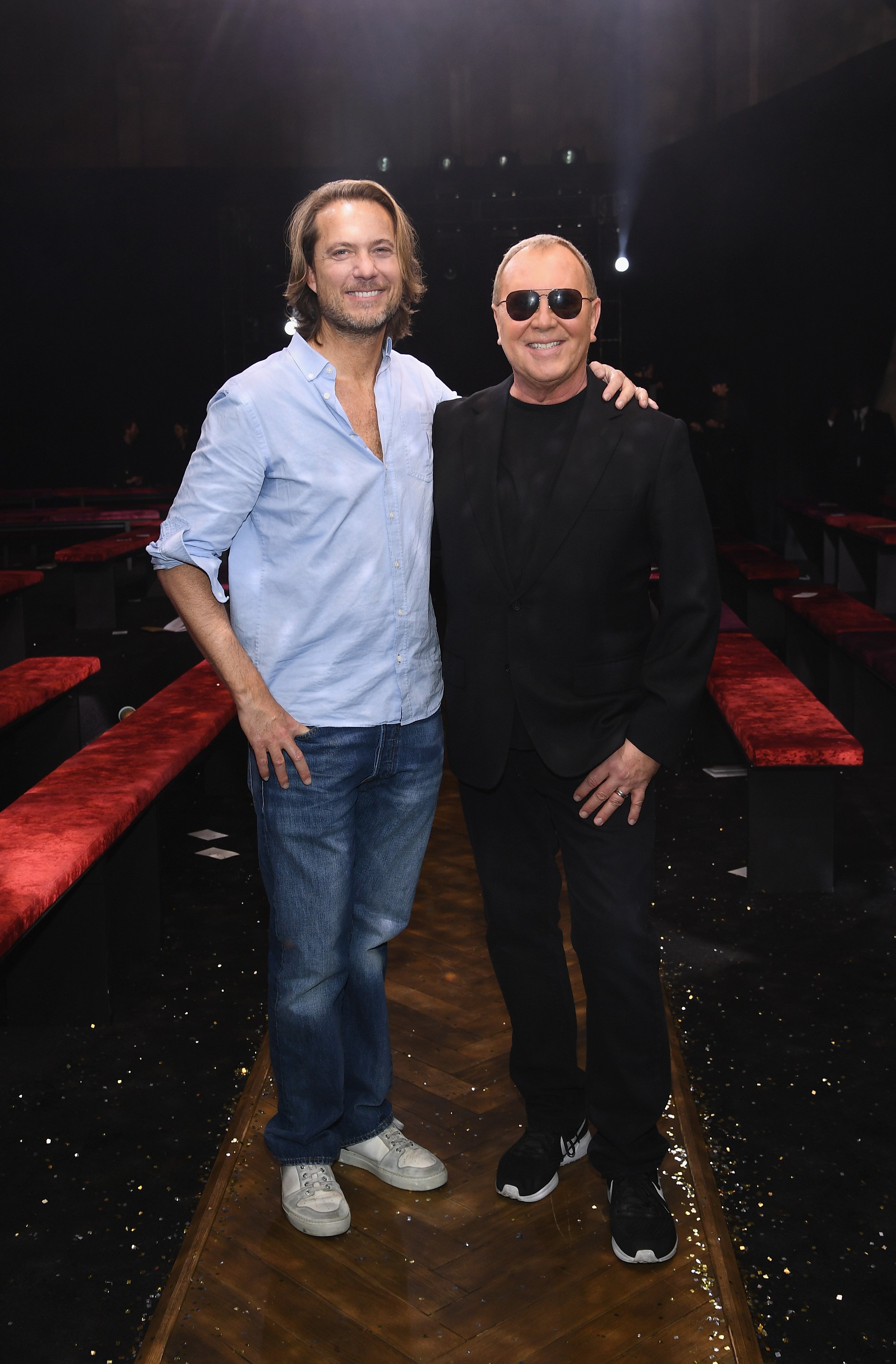 Lance LePere (L) and Michael Kors pose on the runway during Michael Kors Collection Fall 2019 Runway Show at Cipriani Wall Street on February 13, 2019, in New York City. | Source: Getty Images.