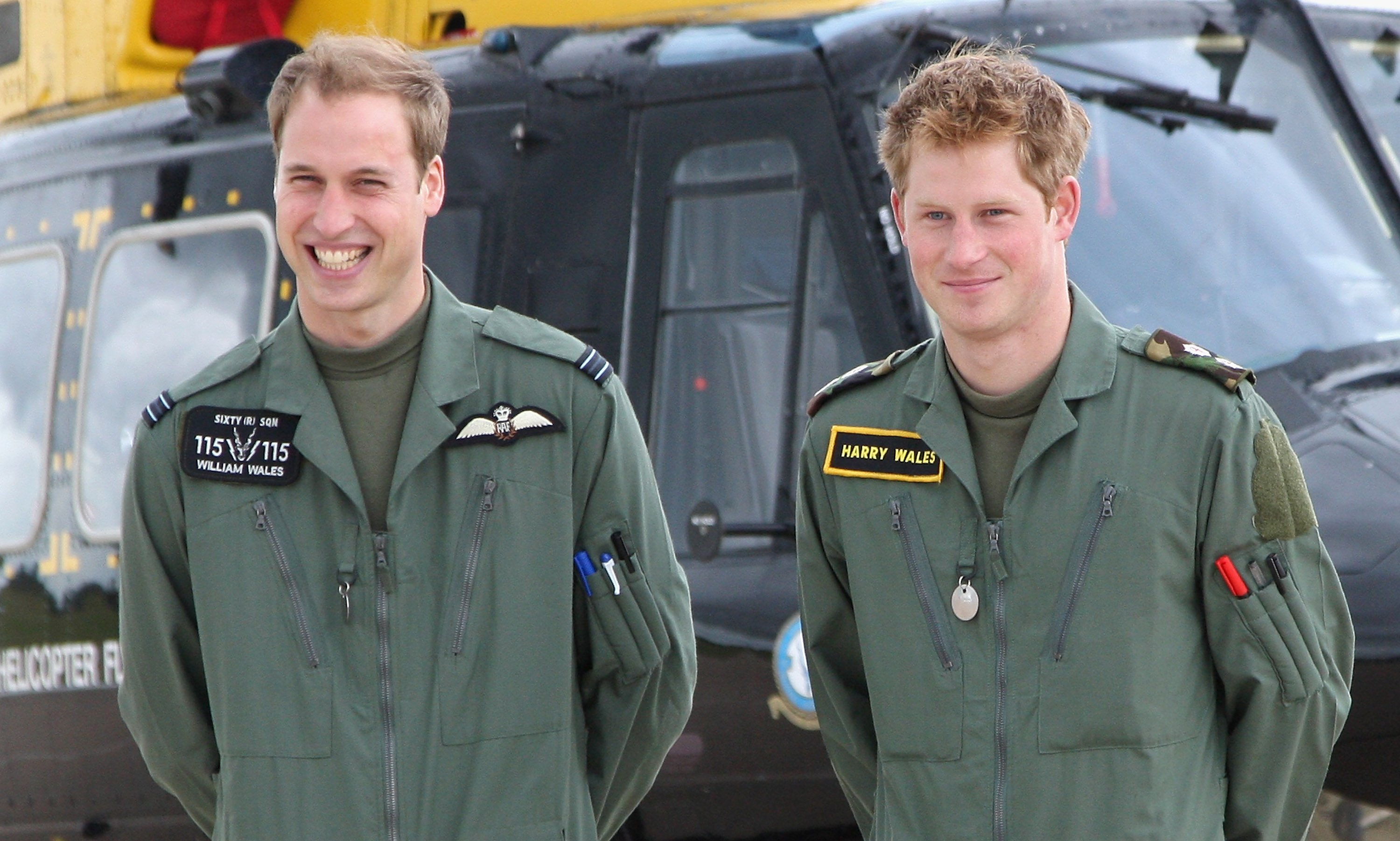 Prince William and Prince Harry pose in front of a Griffin helicopter during a photocall at RAF Shawbury on June 18, 2009, in Shawbury, England. | Source: Getty Images