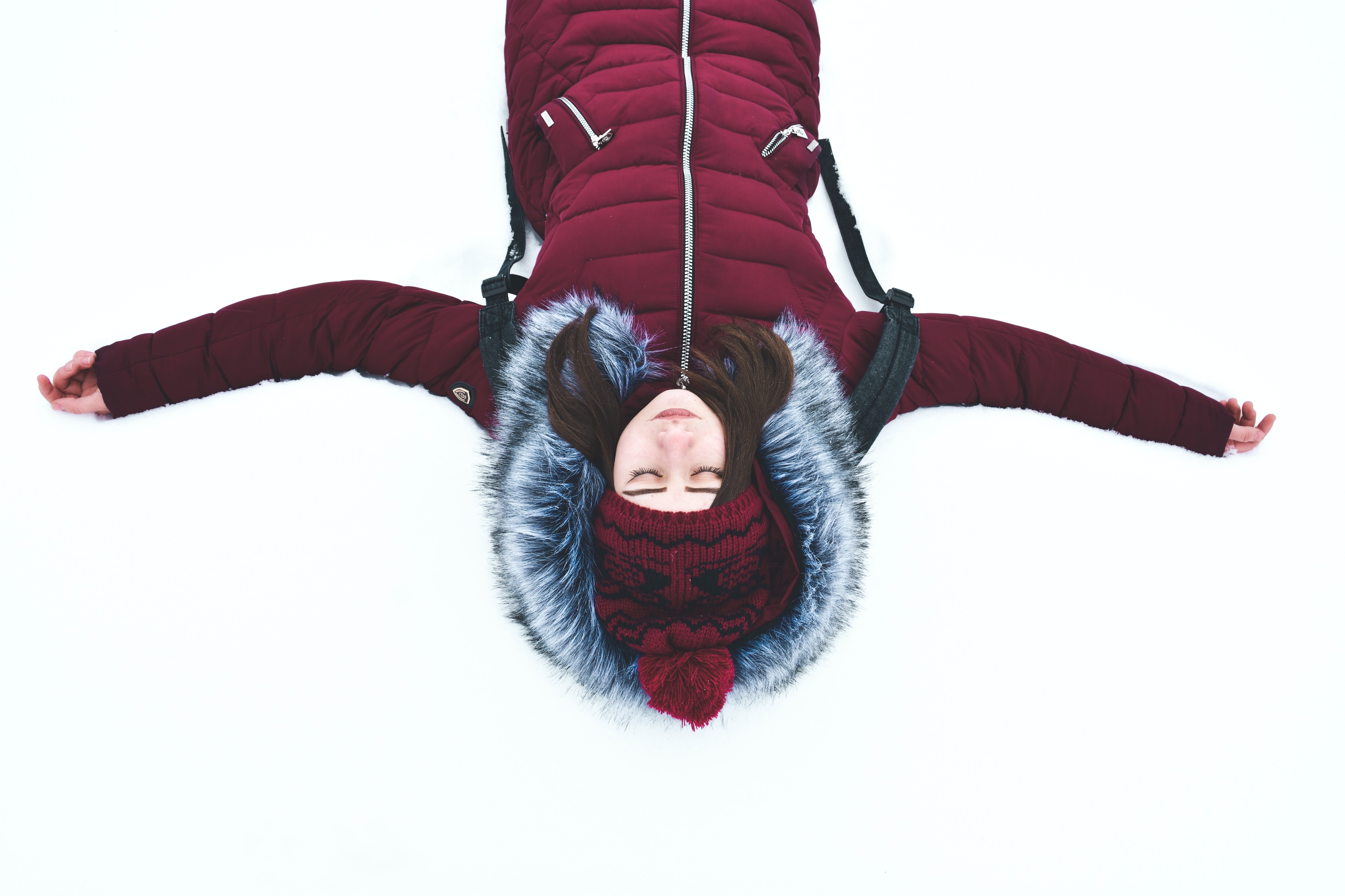 An image of a woman lying in the snow. | Source: Pexels