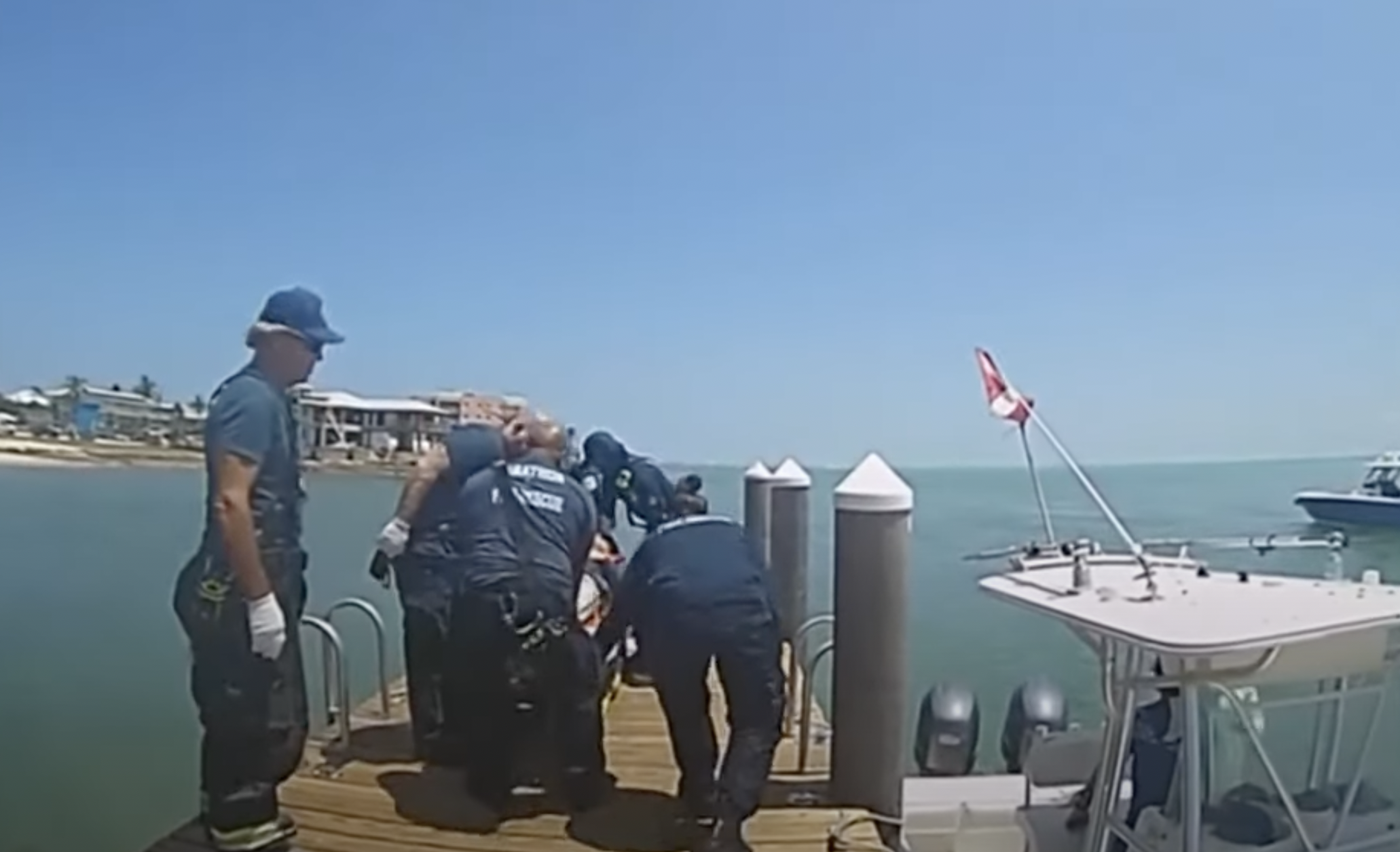 Lifeguards are on a dock in Florida. | Source: https://www.youtube.com/watch?v=S-Sosp21blo