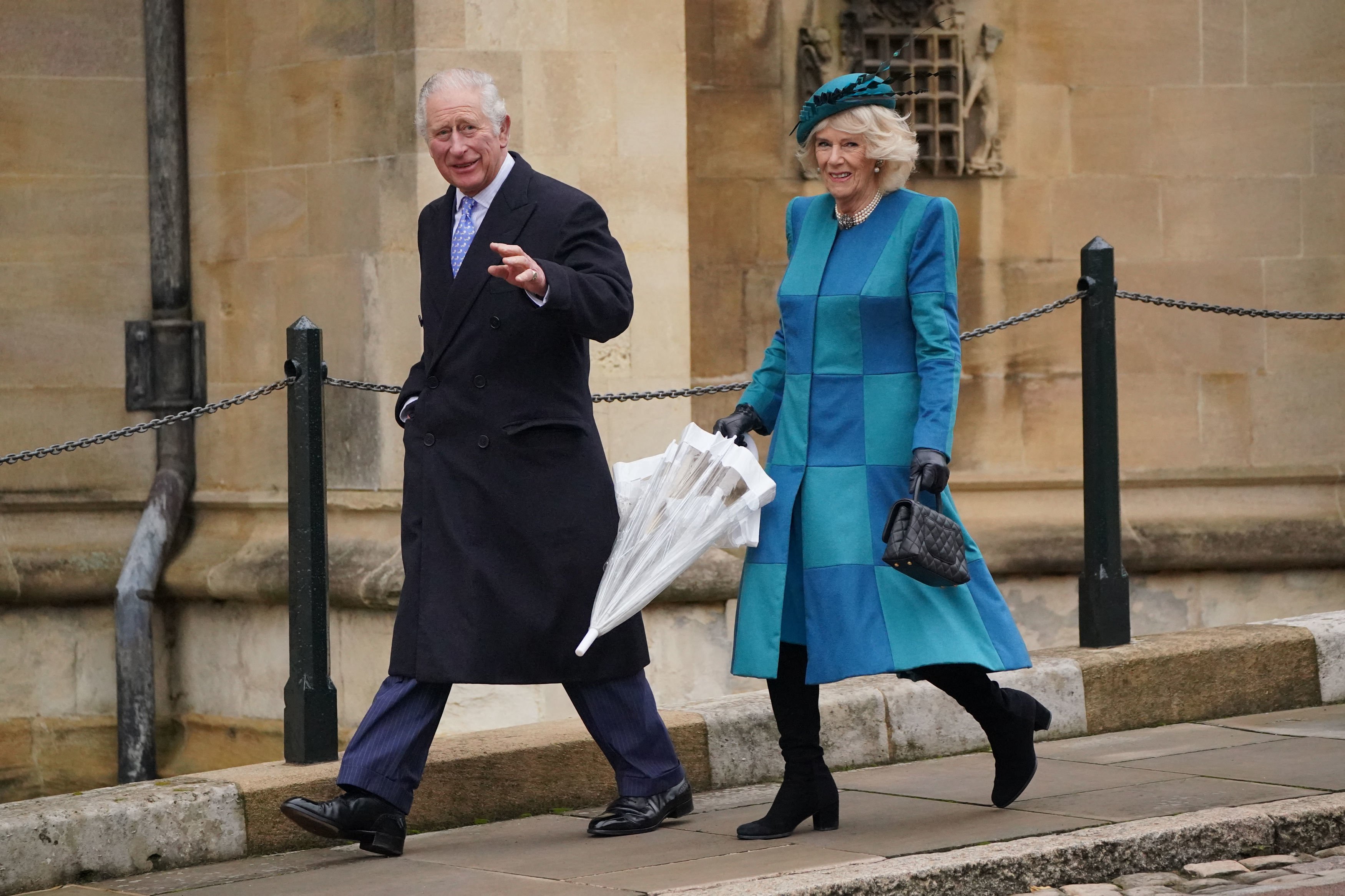 Britain's Prince Charles, Prince of Wales (L) and Britain's Camilla, Duchess of Cornwall arrive to attend the Christmas Day morning church service at St George's Chapel, Windsor Castle, Berkshire on December 25, 2021. | Source: Getty Images