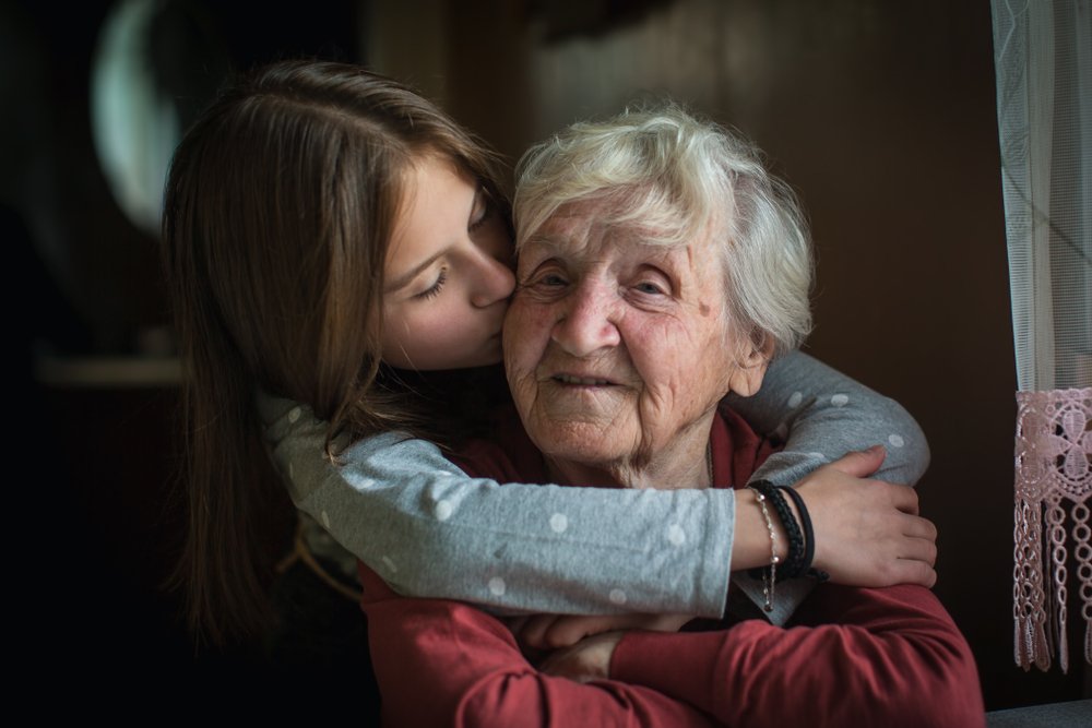 Hugs and kisses from a granddaughter to her grandma | Photo: Shutterstock