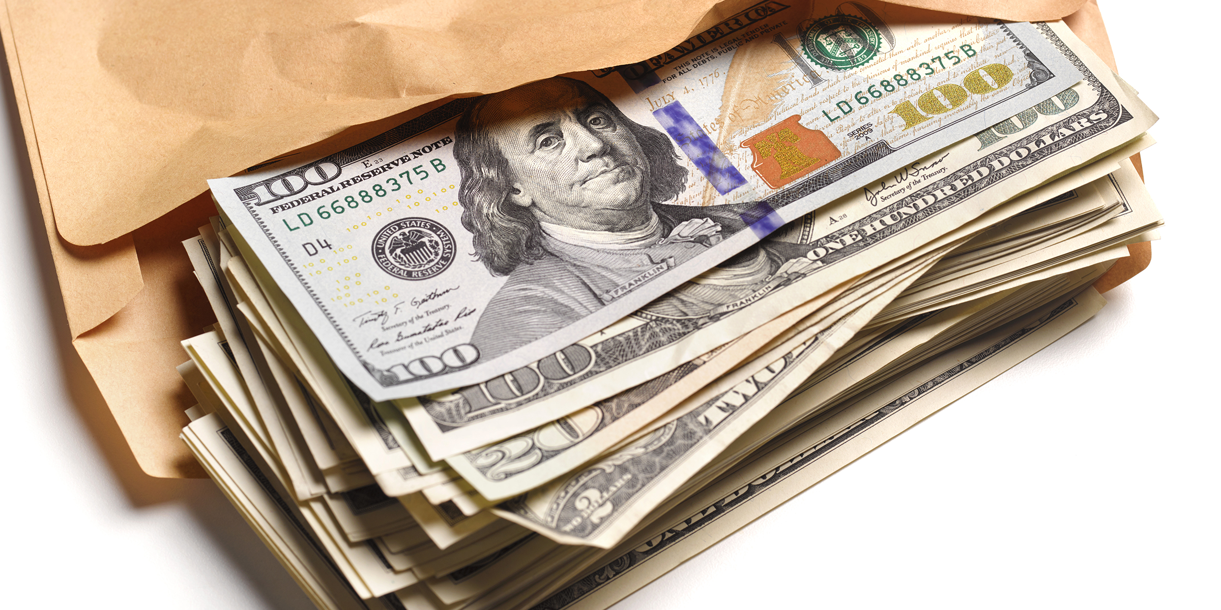 An envelope filled with dollar bills | Source: Getty Images