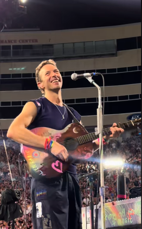 Chris Martin laughs along with the crowd as he jokes about Astronomer CEO scandal,  from a video post dated July 20, 2025 | Source: TikTok/jarev1