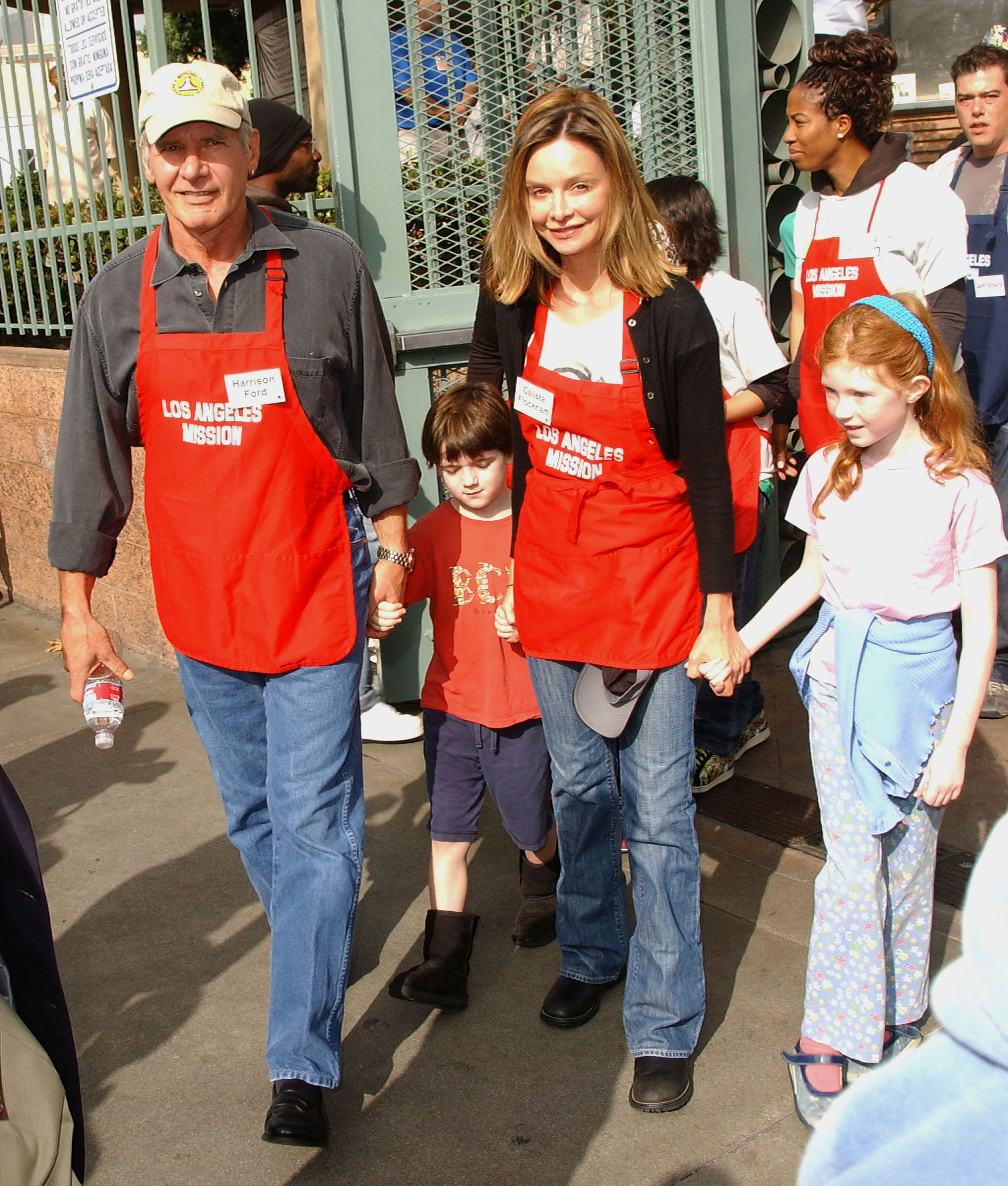 Harrison Ford and Calista Flockhart with son Liam participate in serving Thanksgiving dinner to the Skid Row homeless at the Los Angeles Mission in Downtown Los Angeles, California, on November 21, 2007 | Source: Getty Images