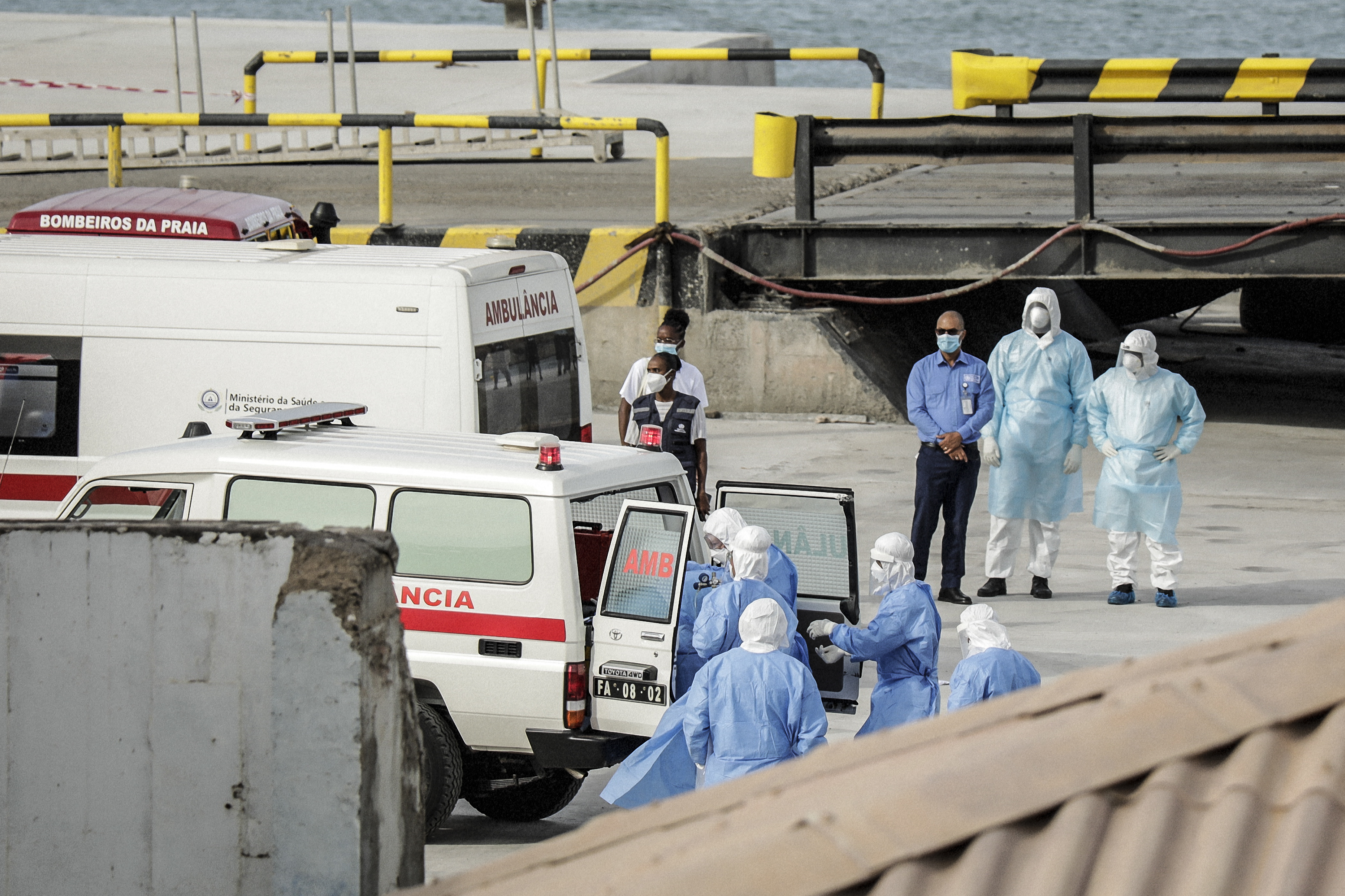 Health personnel returning from the cruise ship MV Hondius, are seen at the port of Praia, the capital of Cape Verde, as individuals wearing hazmat suits are helped into an ambulance on May 6, 2026 | Source: Getty Images