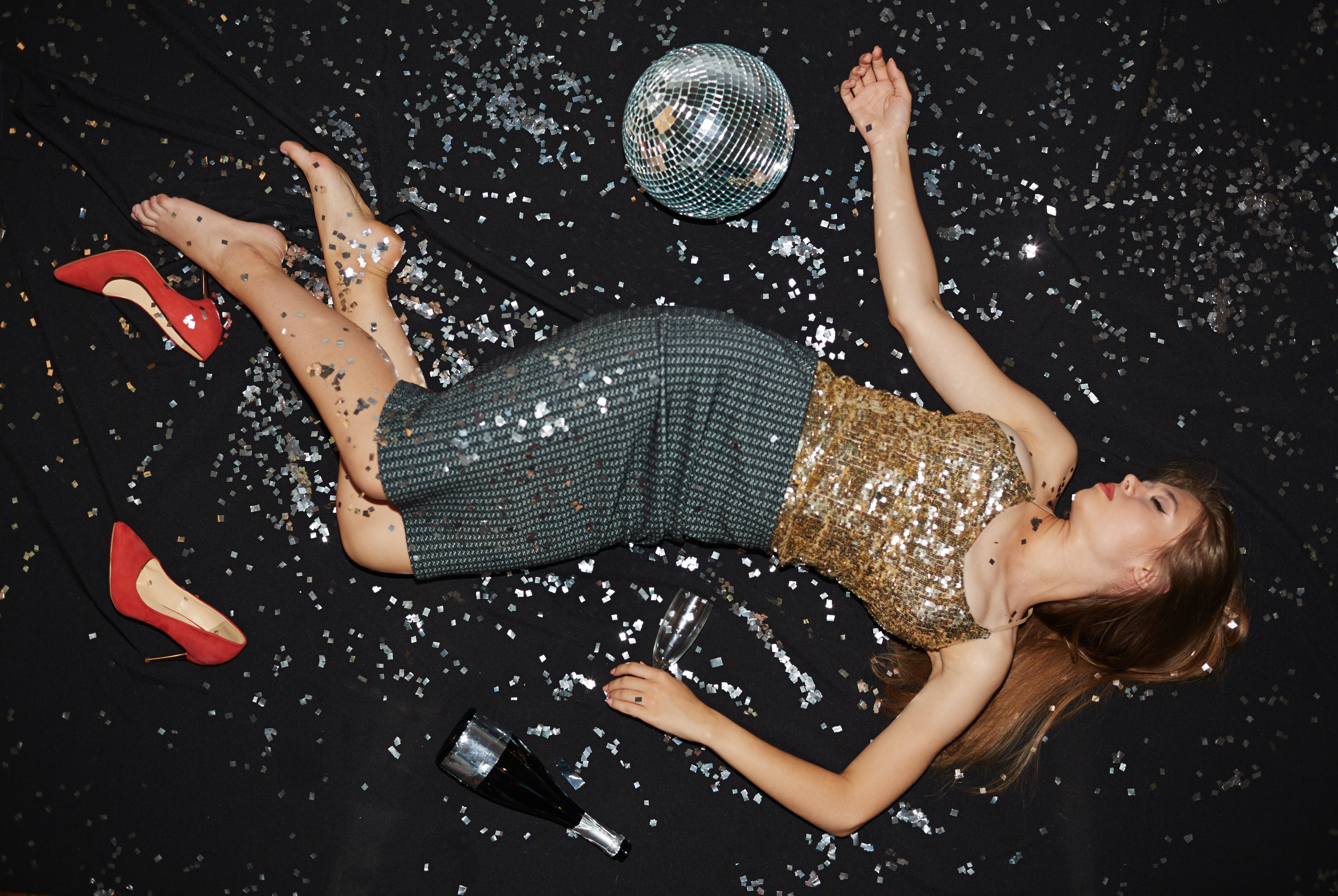 Girl lying on the floor after a party | Source: Shutterstock
