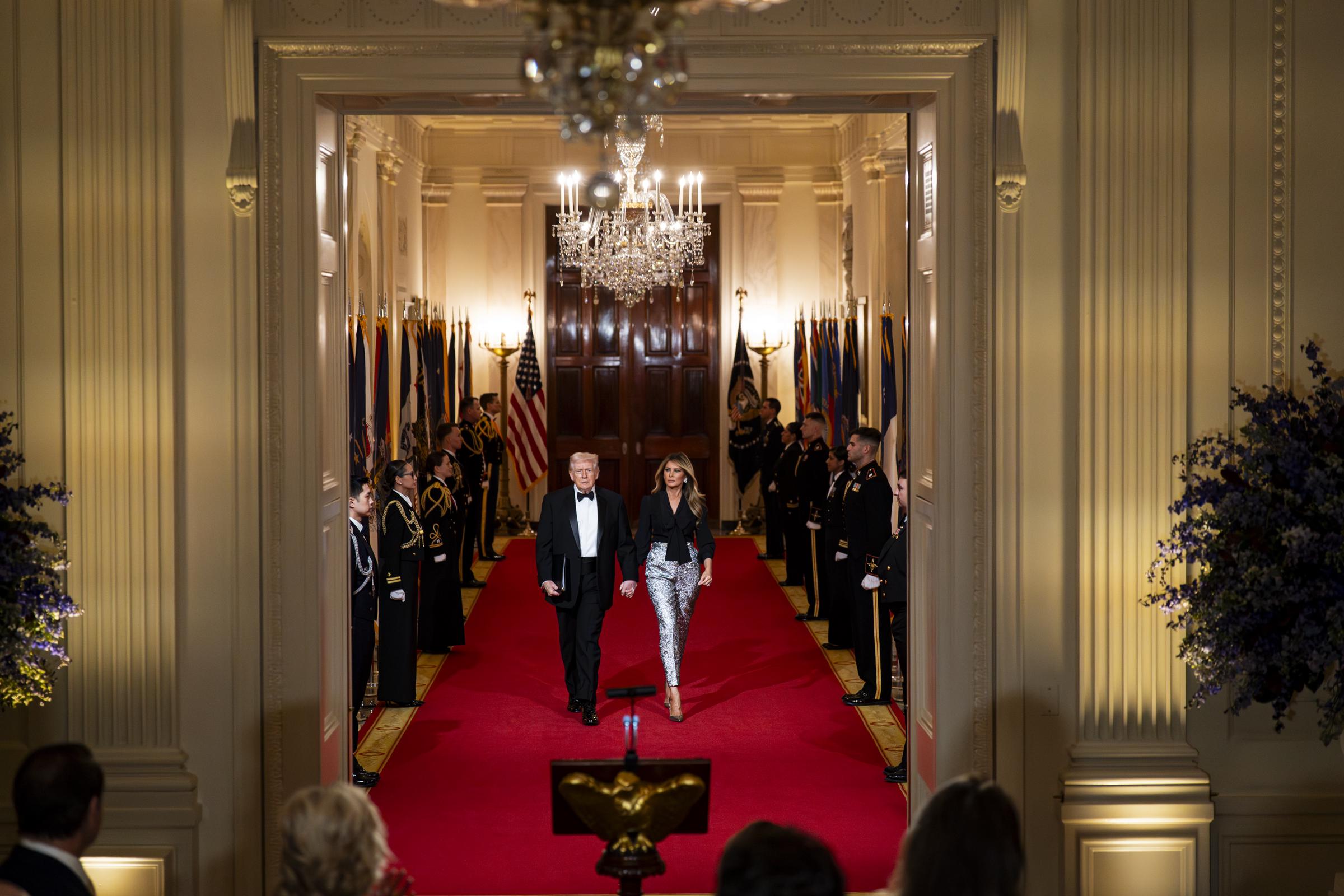 Donald Trump and Melania Trump arrive during the National Governors Association Evening Dinner and Reception in the East Room of the White House on February 21, 2026, in Washington, DC | Source: Getty Images