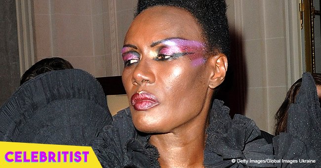 Grace Jones, 70, covers her body in white paint & wears a statement head dress at Bestival 