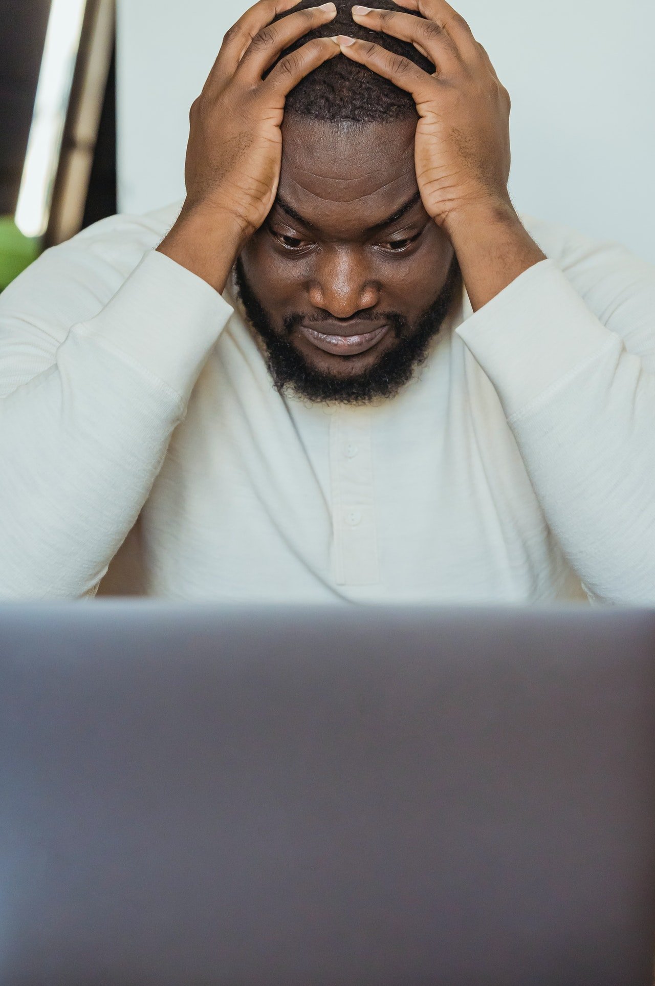 A frustrated man holding his head with both hands. | Source: Pexels