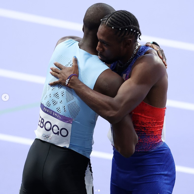 Noah Lyles hugging Letsile Tebogo after the men's 200m final at the Paris Olympics in a photo dated August 9, 2024 | Source: Instagram/nojo18