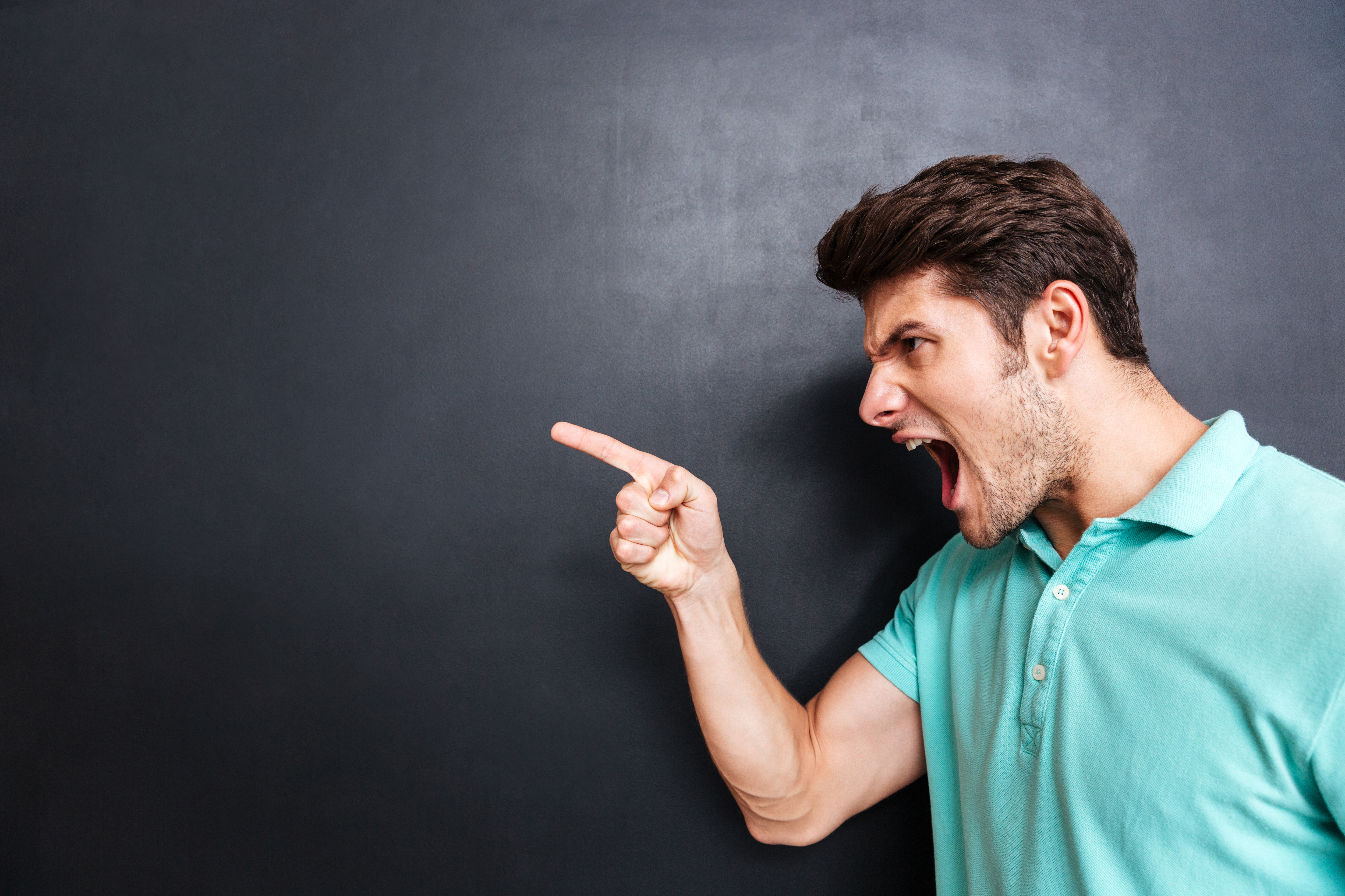 An angry man yelling. | Source: Shutterstock