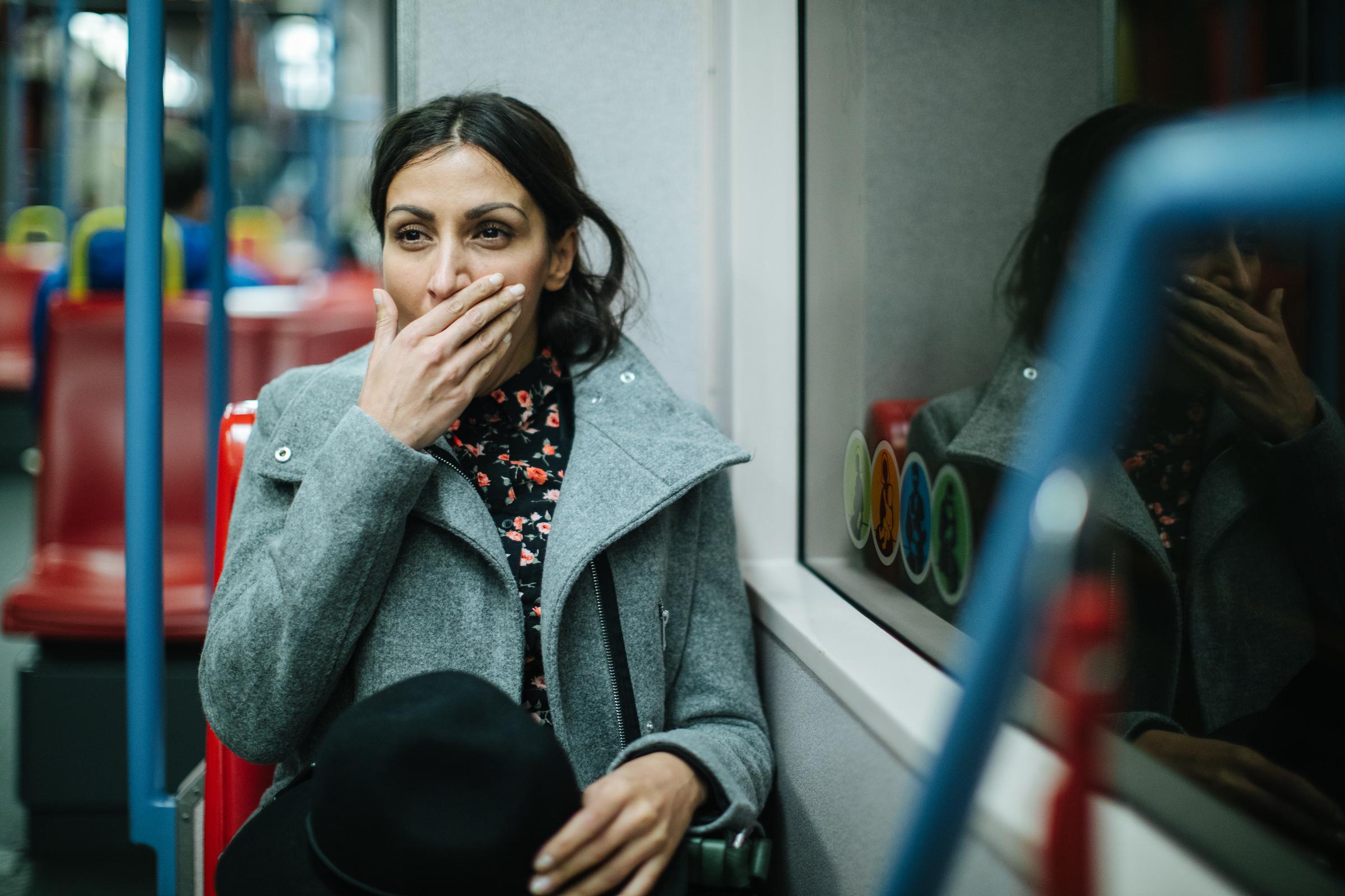 A woman yawning while on a train | Source: Getty Images